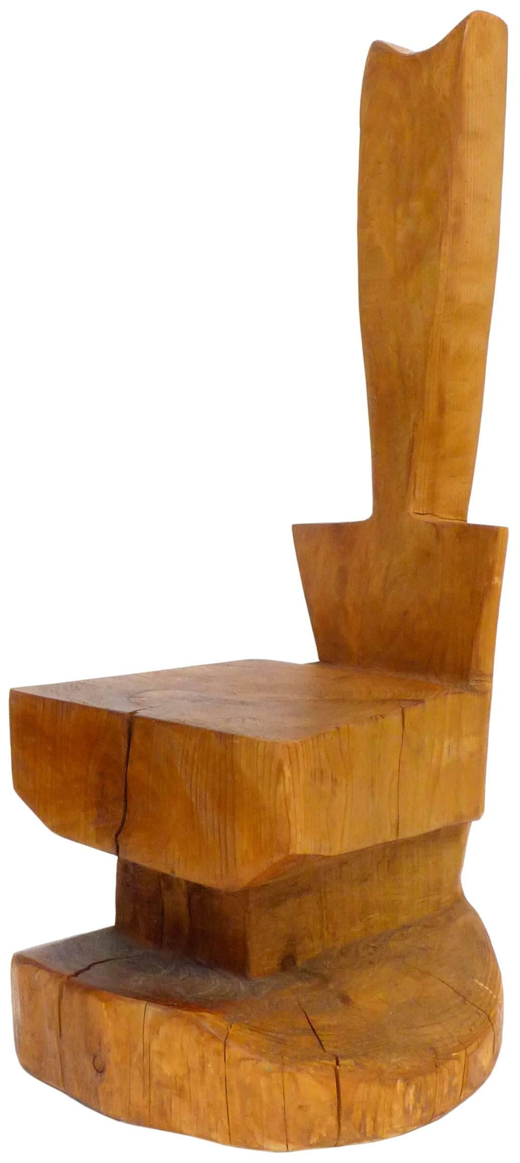 An incredible rough-sawn eucalyptus throne. Sourced from the estate of a Northern California woodworking artist, hewn from one massive hunk of wood, an impressive sculpture of a seating option, clearly primitively inspired in its coarse-modernist