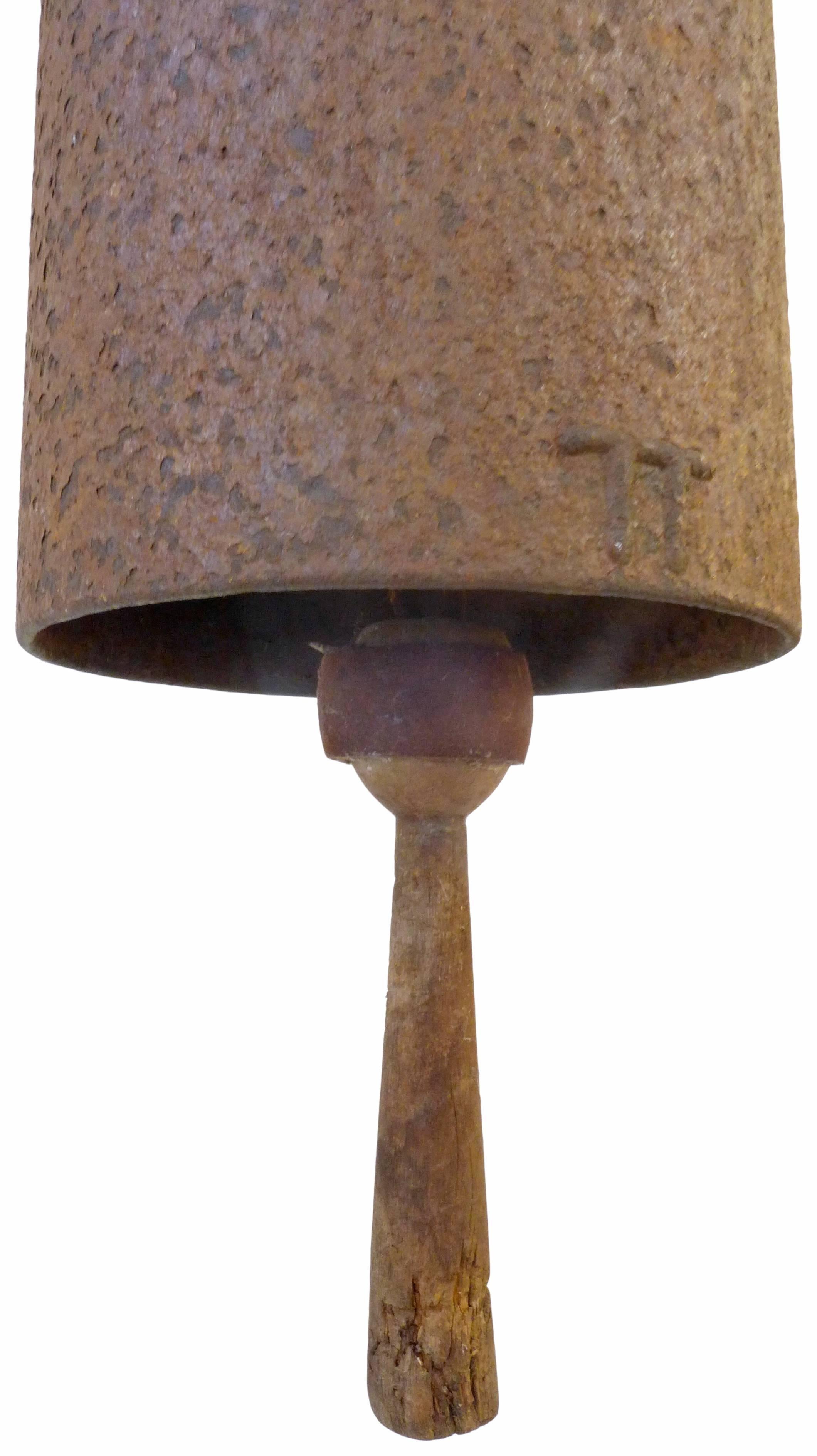 A striking cast iron garden bell. A modernist, sculptural form of clear eastern influence; a simple, domed cylinder wearing a commanding, ethnographic crown. Even oxidization all-over likely from years of life outdoors. A leather-wrapped,
