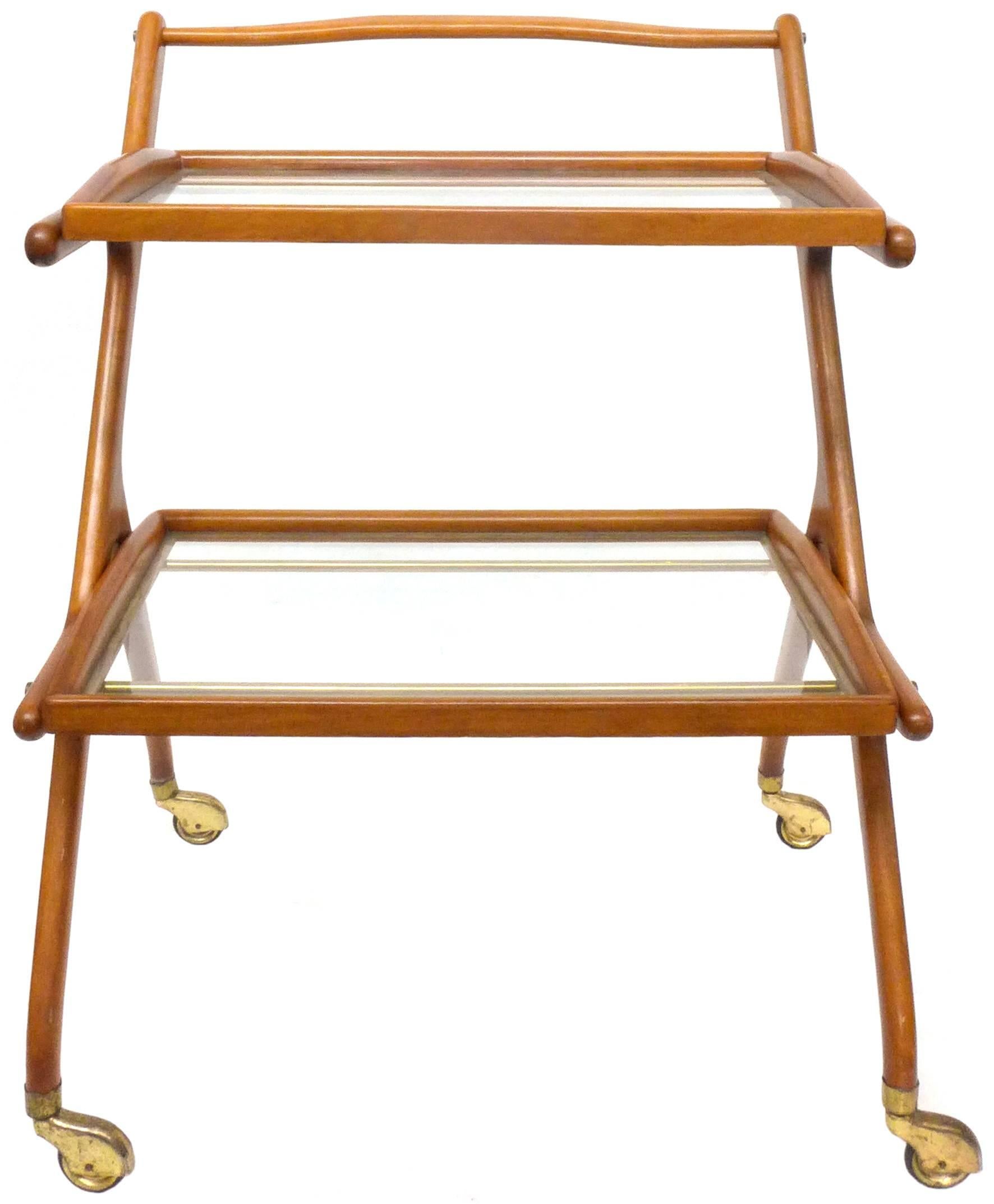 A wonderful 1950s Italian walnut, brass and glass bar cart by Cesare Lacca. A perfect example of Classic, Mid-Century Italian design in wonderful, near perfect, all original condition. An exceptionally decorative and sculptural utilitarian item.