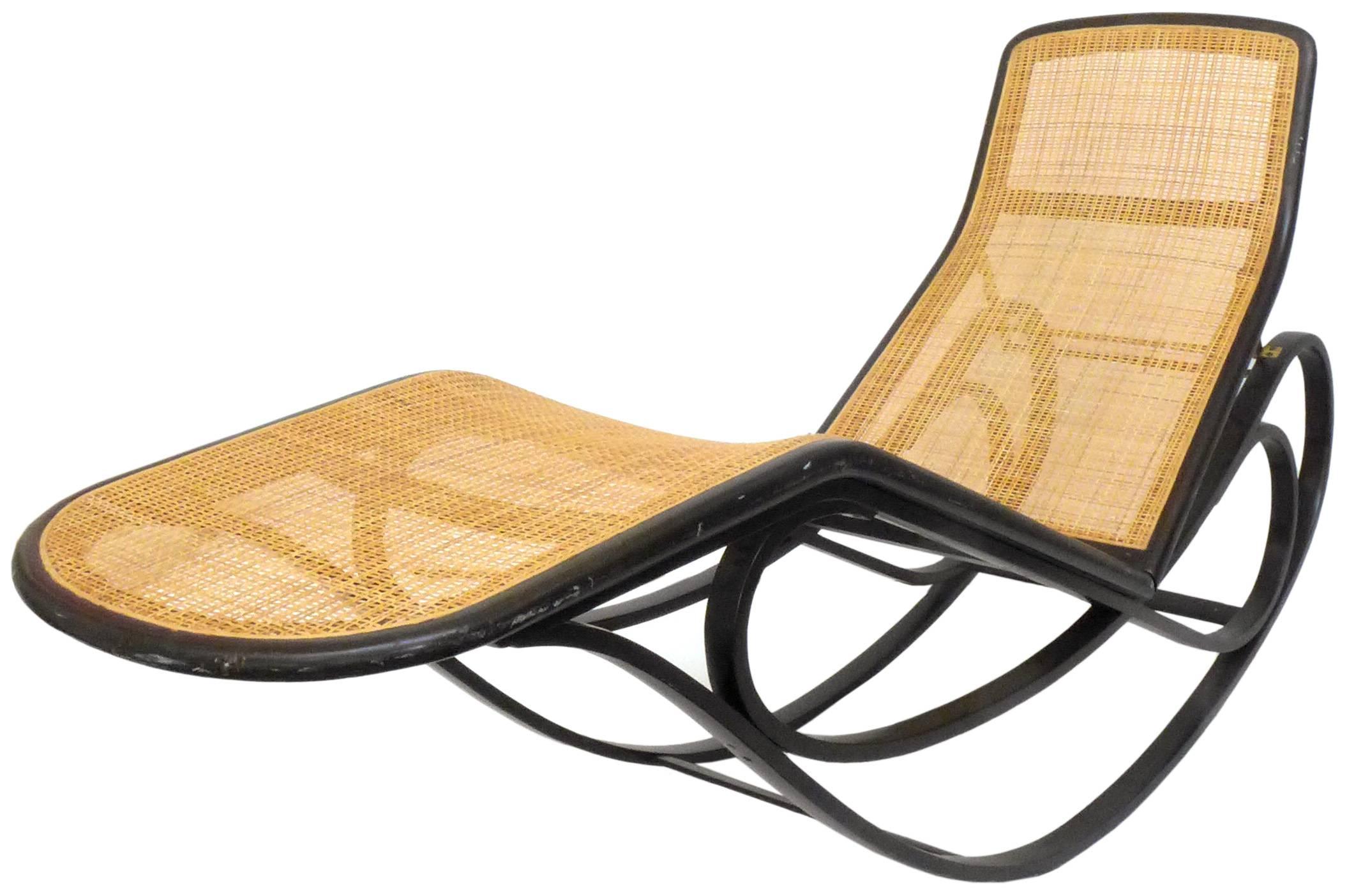 A beautiful and rare rocking chaise lounge by Edward Wormley for Dunbar. A highly-desirable icon of Mid-Century American furniture, a Thonet-inspired piece in bent ash, woven cane, and brass. Back-height is adjustable to three positions. In great,