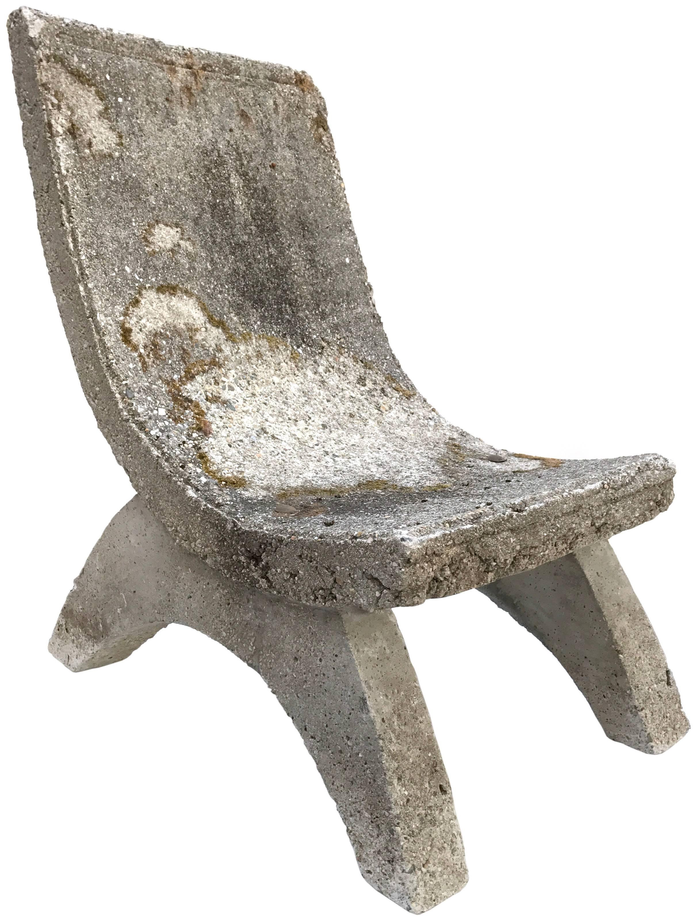 A monumental cast concrete garden chair. An architectural form with a dramatic, sloping seat resting on widely splayed, arch leg-structures. Incredible, impressive scale and proportions. Great patina and textured surface from years of life outdoors.