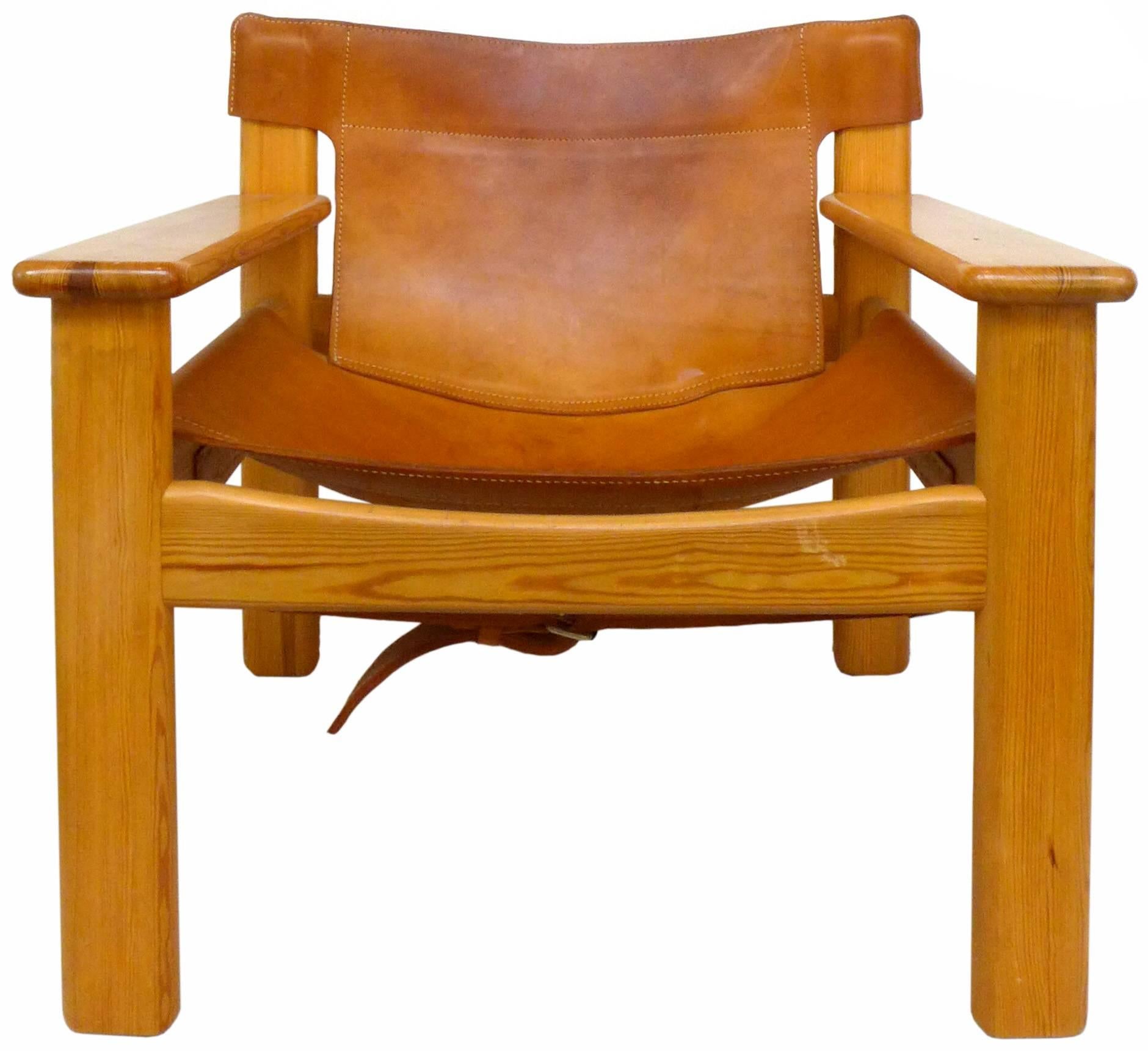 A strikingly handsome pair of leather and pine "Natura" Chairs designed by Karin Mobring. Wonderful construction and patina to both the saddle leather and wood elements. A rugged and very chic seating statement, very reminiscent to the