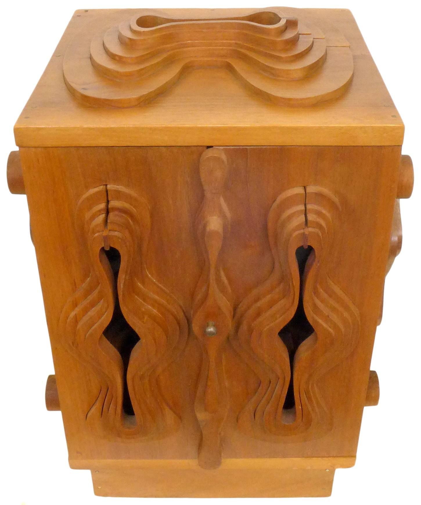 A wonderful and unusual sculpture cabinet by designer John Risley. Known for his furniture designs, Risley's talents veer into fine art as well, of which this cabinet is certainly an unusual example. A beautifully crafted cabinet with stepped,
