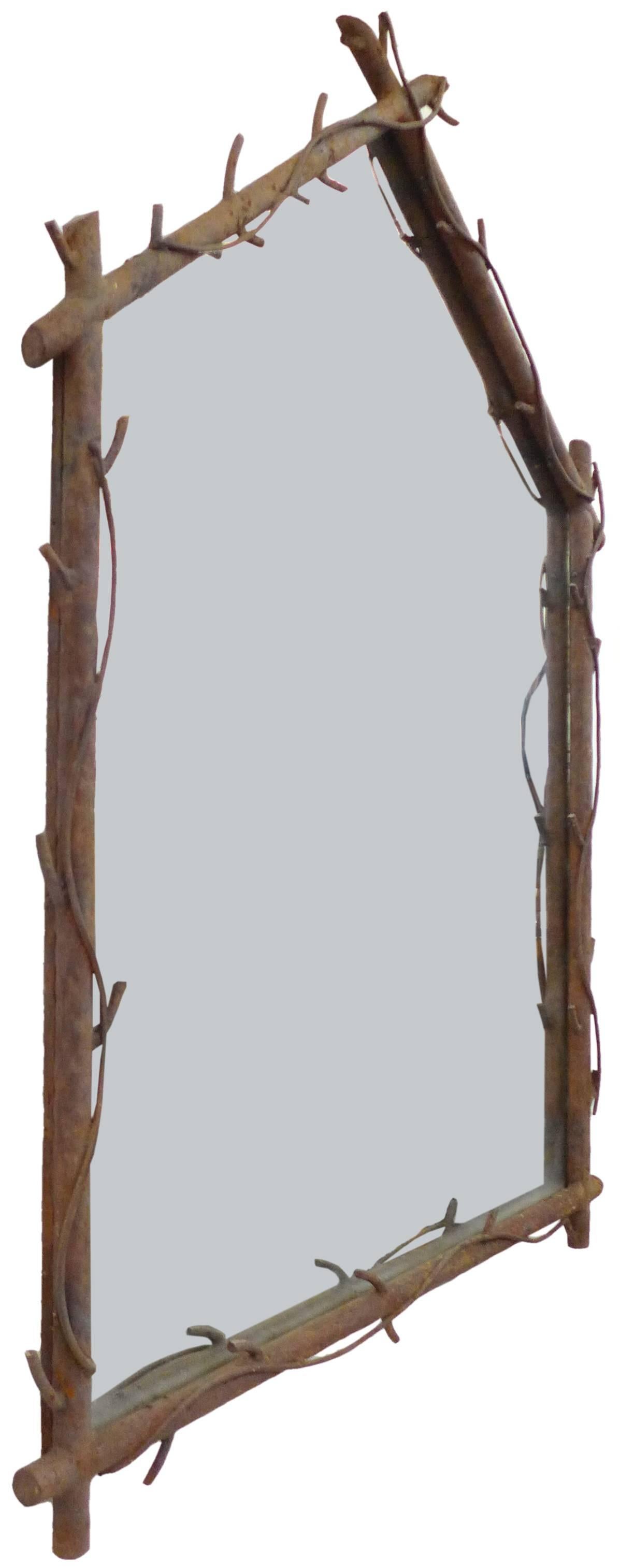 A substantial and extraordinary welded-steel, faux-bois mirror.  A wonderfully evocative, scratch-built, likely one-of-a-kind construction of intersecting tubular-steel shafts wearing simple, subtly-stylized, broken-off branches and vines; combining