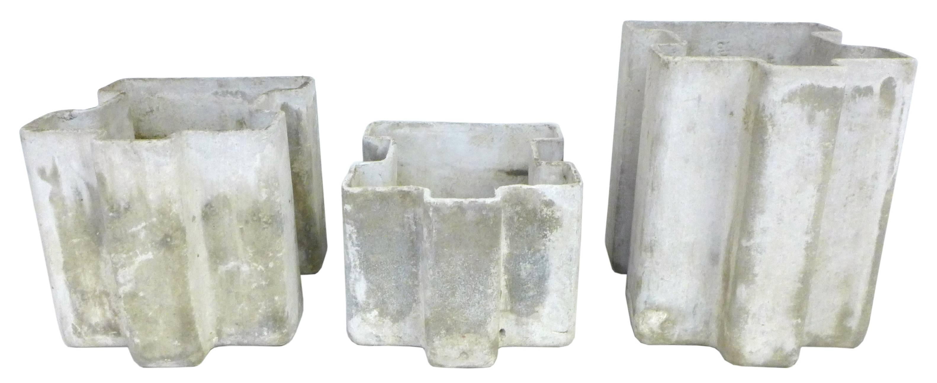A wonderful trio of cast fibercrete planters. A fantastic, compact, unexpected geometric form seemingly extruded to three different heights. Each planter wearing a perfect, much-desired patina from years of life outdoors. Very much in the style and
