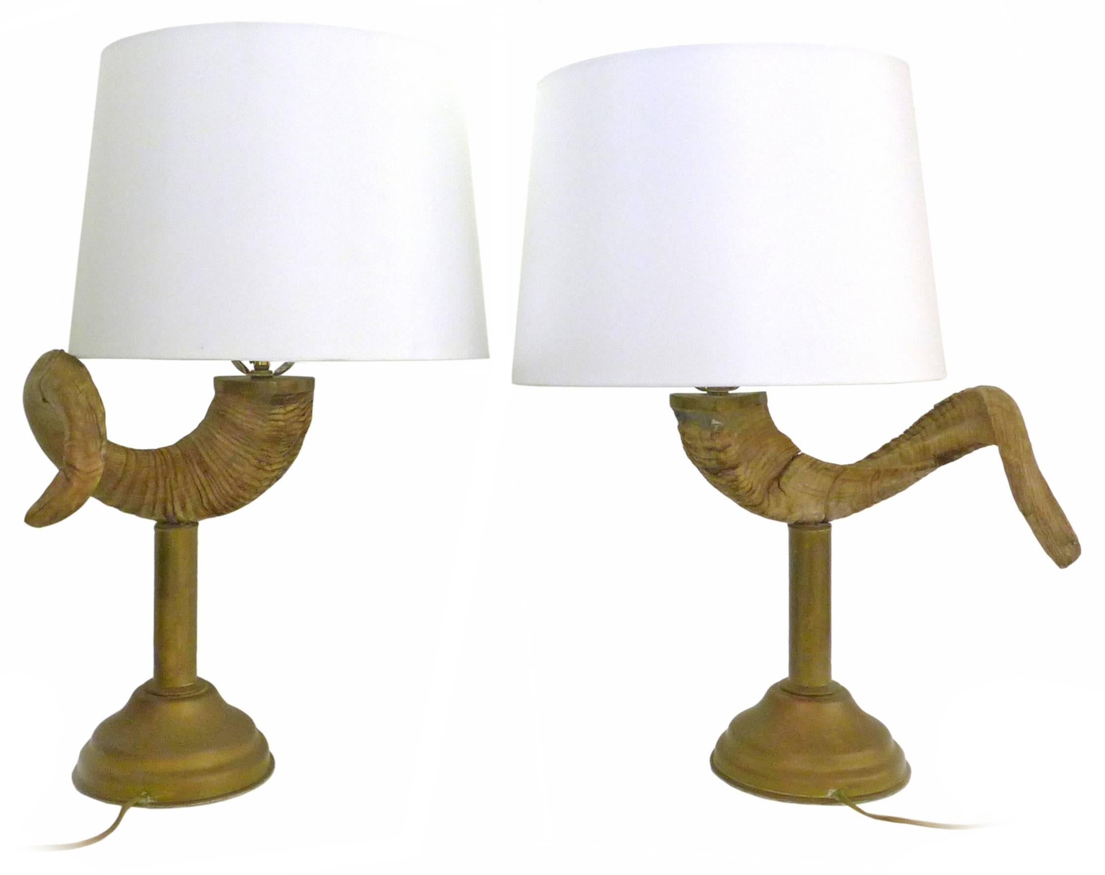 A handsome pair of brass and ram's horn table lamps. Possibly by Chapman Lighting, Classic 1970s American chic; weaving an unexpected yet provocative and powerful organic element with a subtly detailed, perfectly-patinated brass base. Great scale