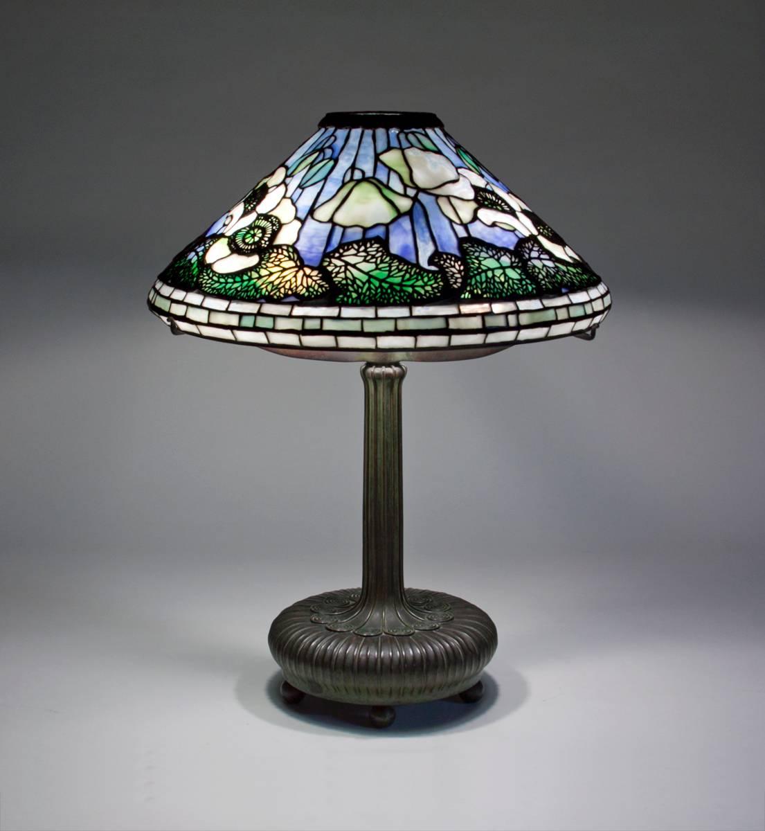 A Tiffany Studios leaded glass and bronze table lamp comprising a 