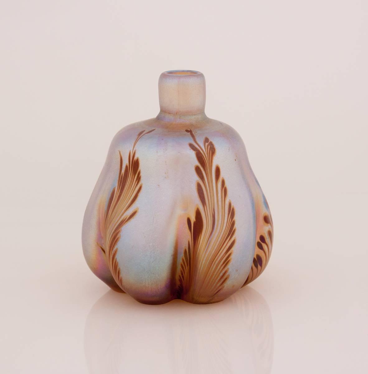 An early Tiffany Studios favrile glass lobed vase decorated with maroon feathering, signed.
