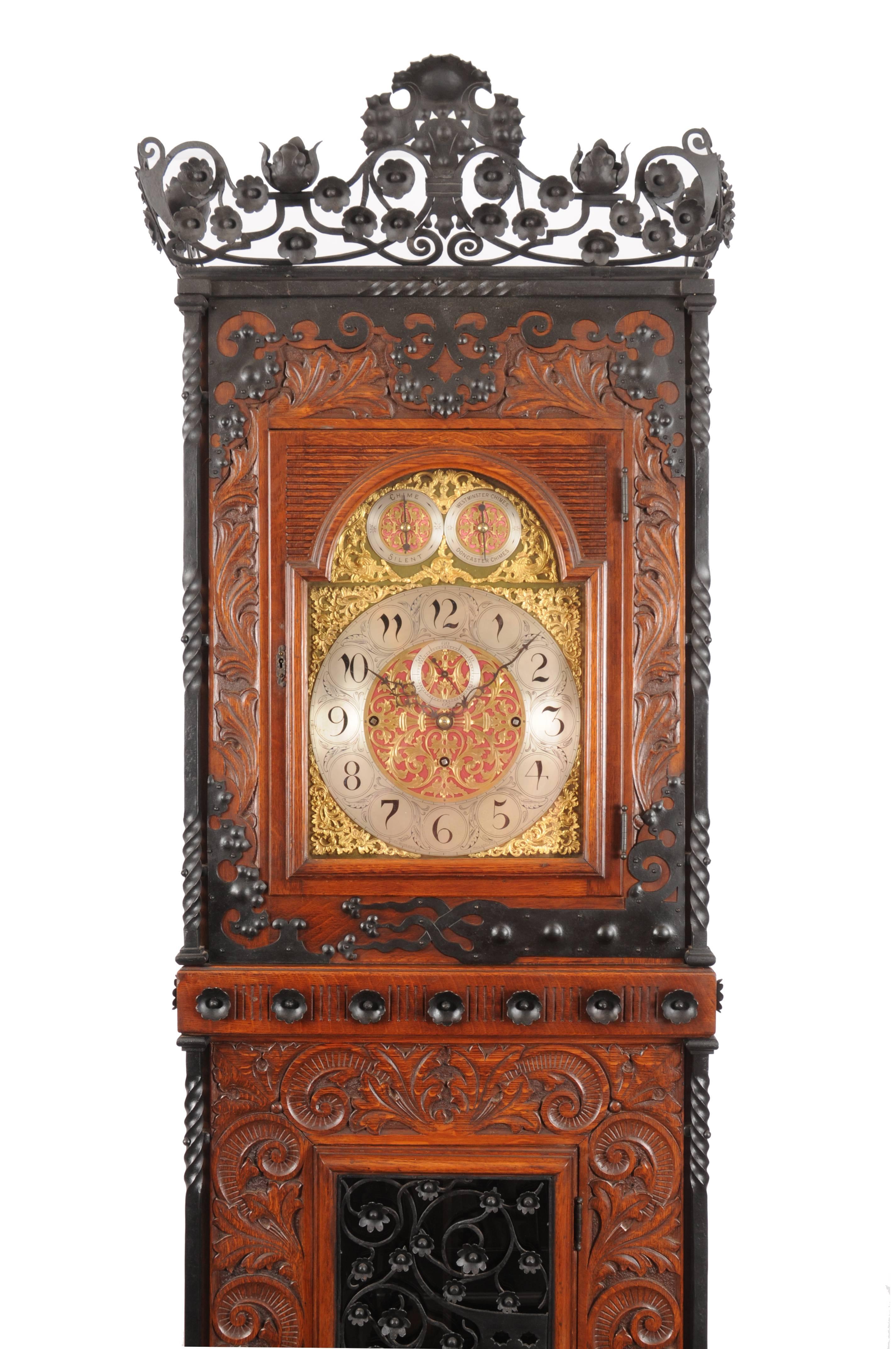This impressive clock is a rare example of a fully developed early Arts & Crafts or Aesthetic Movement hall clock. The unique nature, large scale and extensive use of handcrafted ornamental embellishment suggest that it was produced as a special
