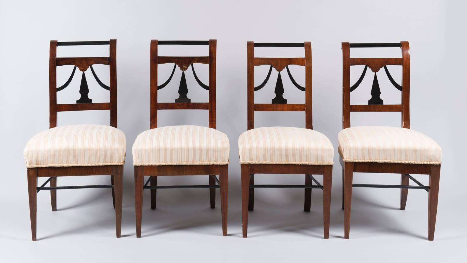 Set of four biedermeier chairs. Walnut veneer with ebonized detailing.