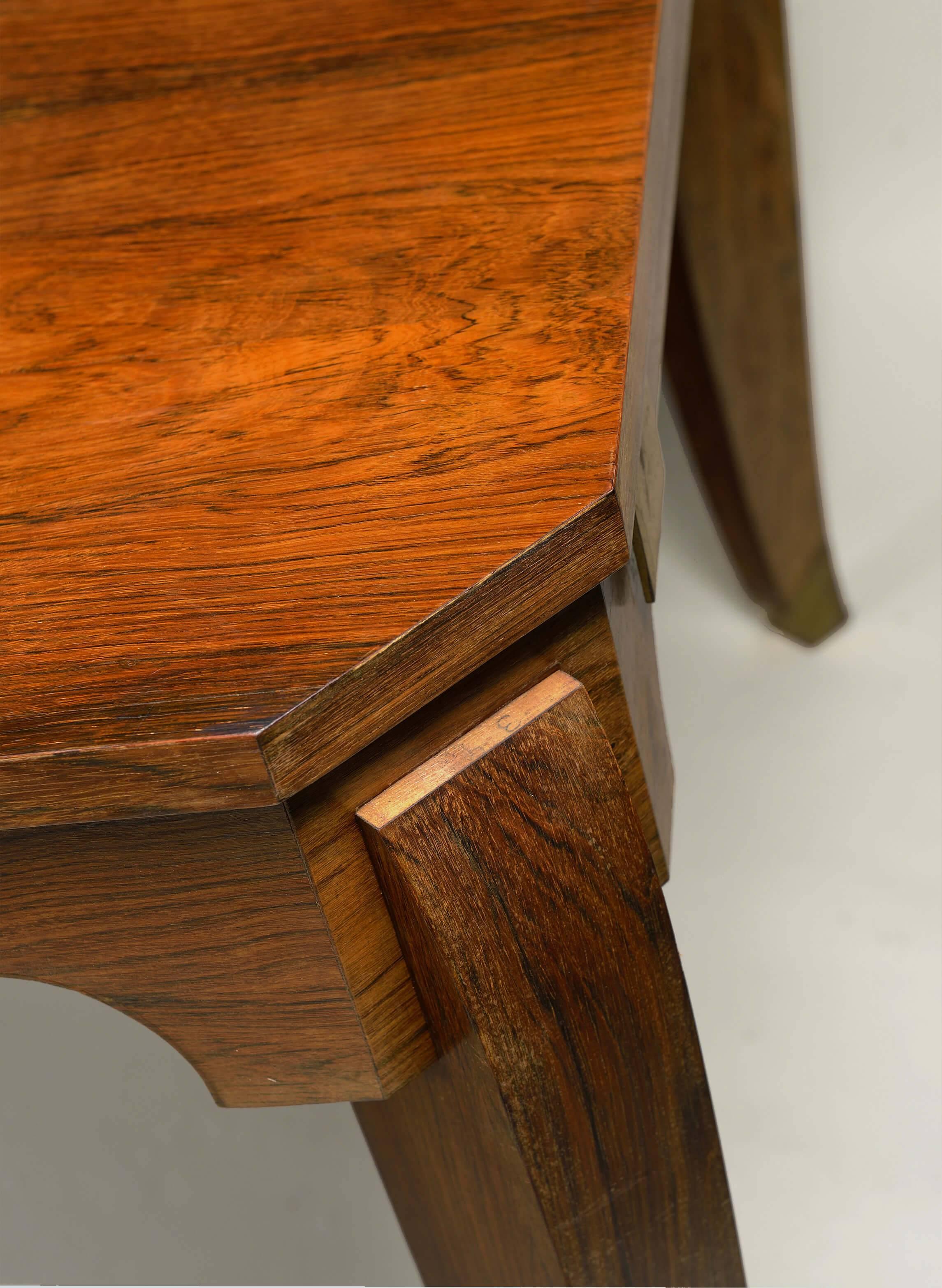 Book-matched rosewood with two extension leaves. Fully extended - 111" wide (two extension leaves).