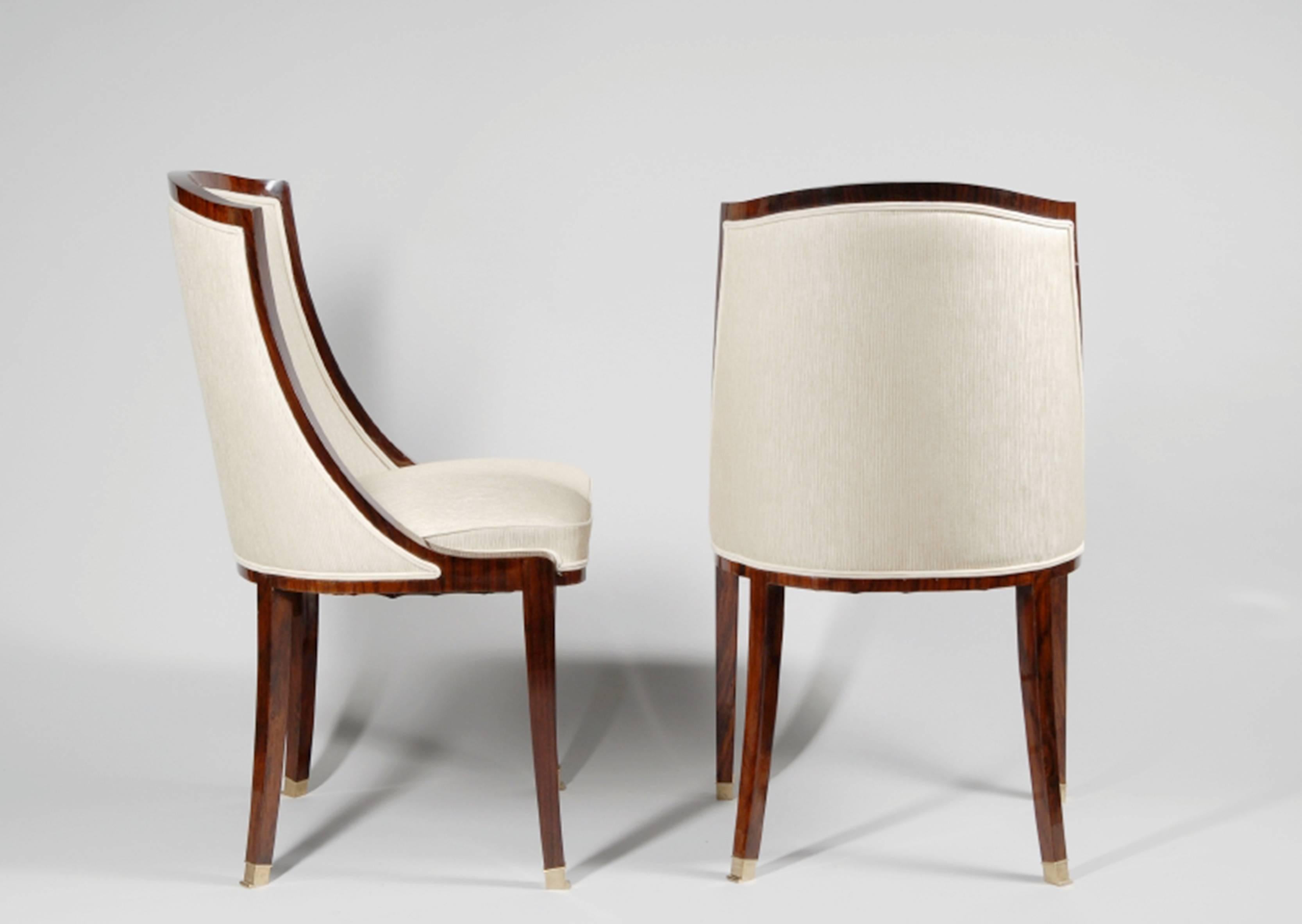 A set of four Art Deco side chairs with rosewood veneer and brass sabots, France, circa 1930.