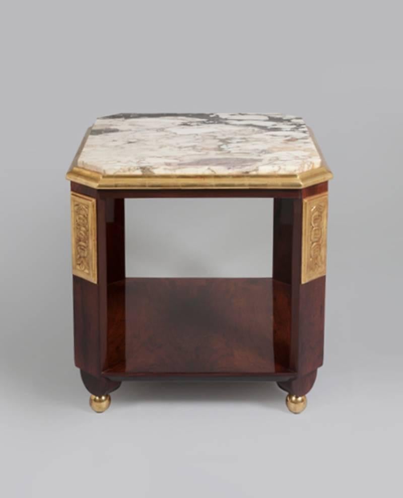 With marble top, rosewood veneer and hard-carved gilt details.