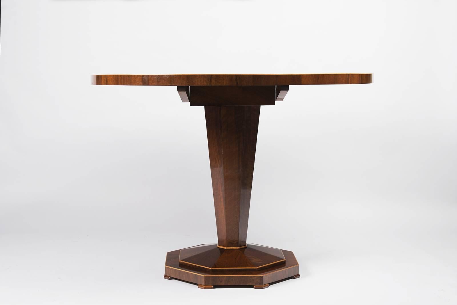 Bookmatched walnut veneer with maple detailing and a tapered hexagonal pedestal base, Central Europe.