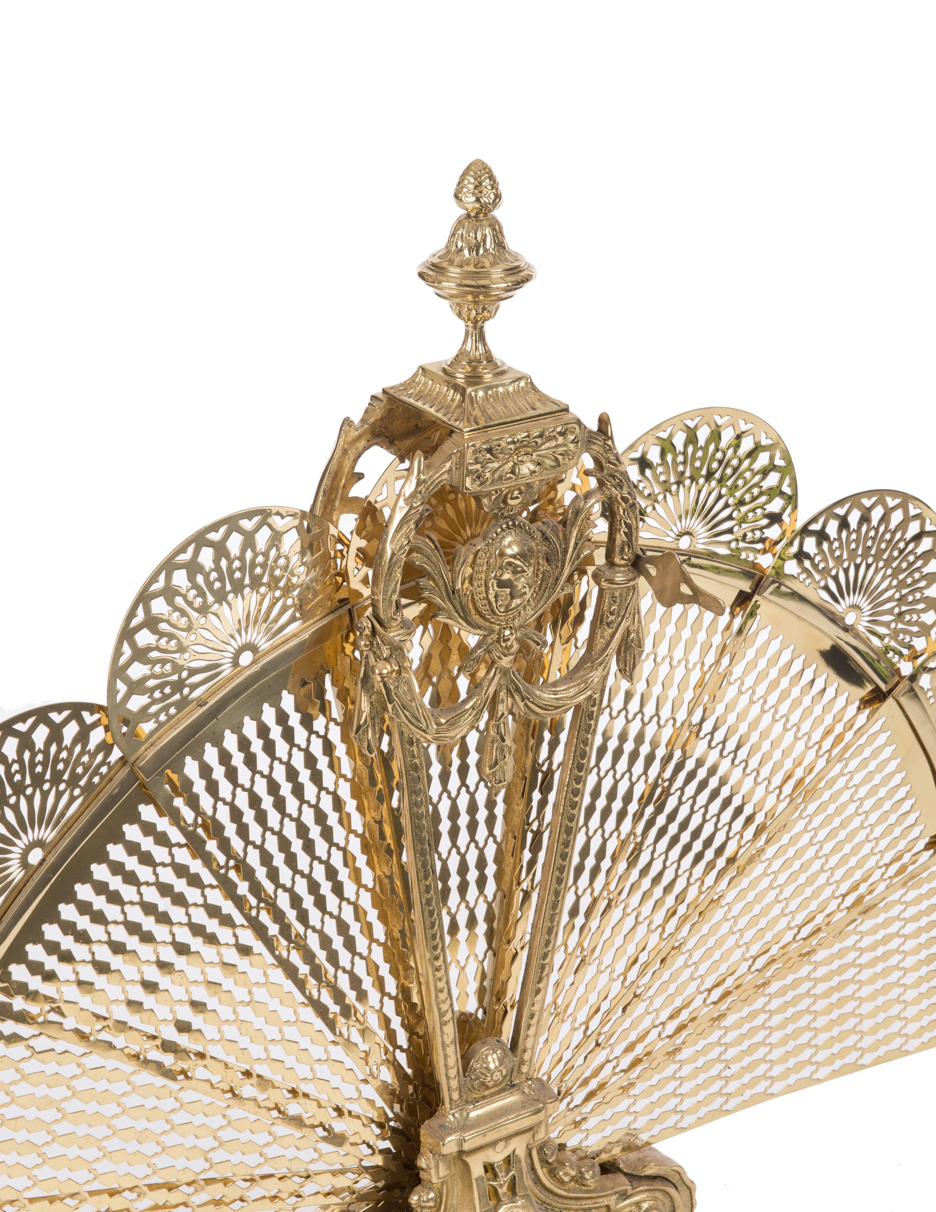 Late 19th century bronze doré and brass peacock fan style fireplace screen made of ornate designs and a lady cameo face on both sides. This screen is much heaver than the 20th century screens of the same design. 

Measures: 28” tall, 38” when