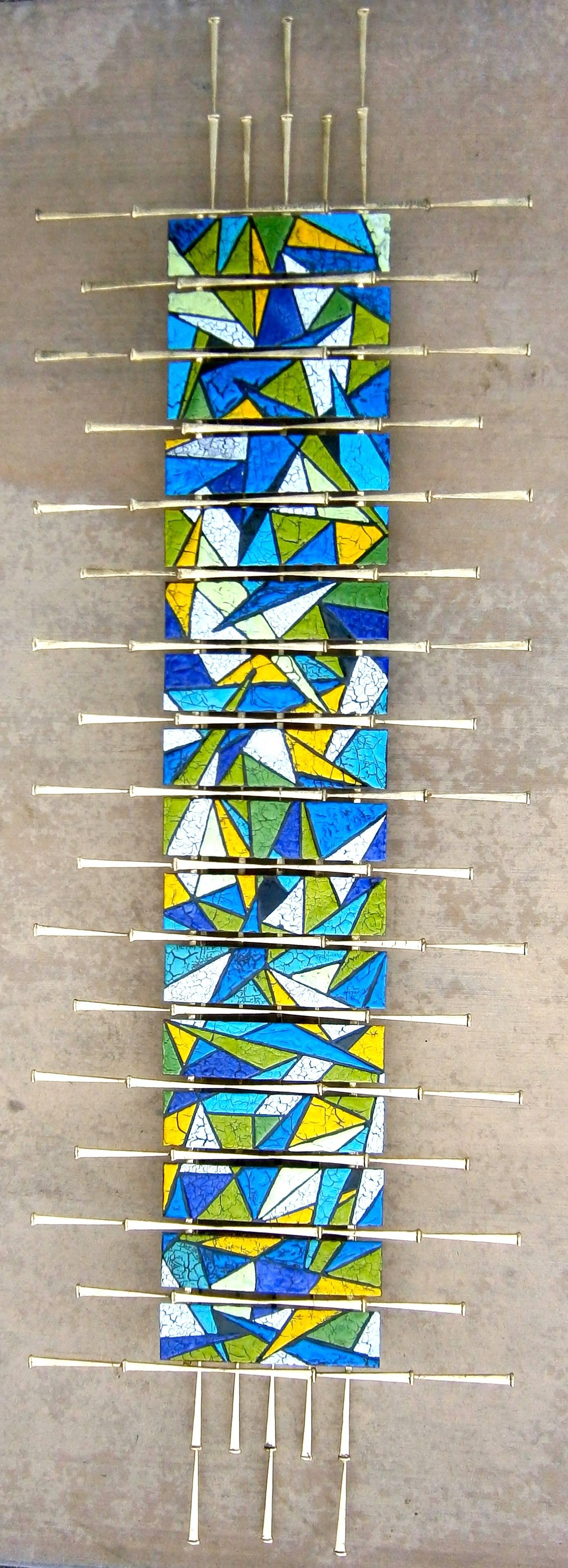 A vividly colorful contemporary wall sculpture by American studio artists Del and Brenda Williams. Composed of a metal framework that is finished in gold leaf, the enamel slats were hand-made and are reminiscent of vibrantly colored stained glass