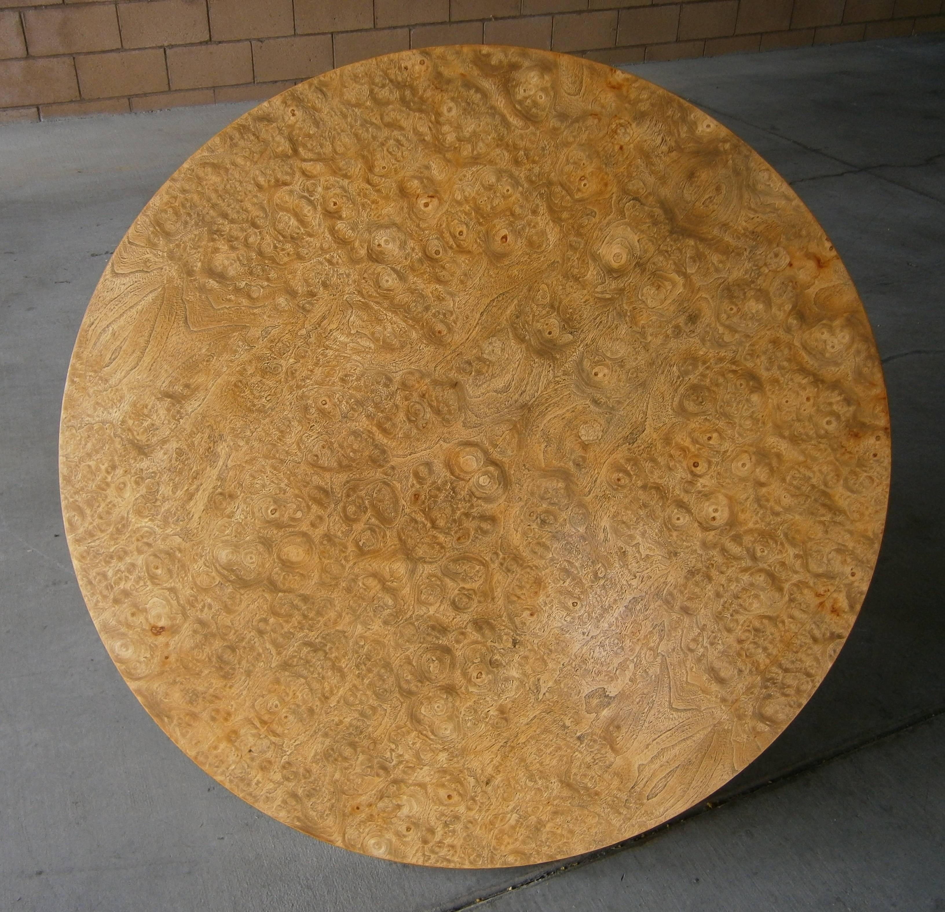 A circular dining or center table designed by John Vesey in 1958. The barrel-form base of the table is fabricated from slightly bent bands of aluminum and brass and the addition of the burled wood top is original to the table. The table was acquired