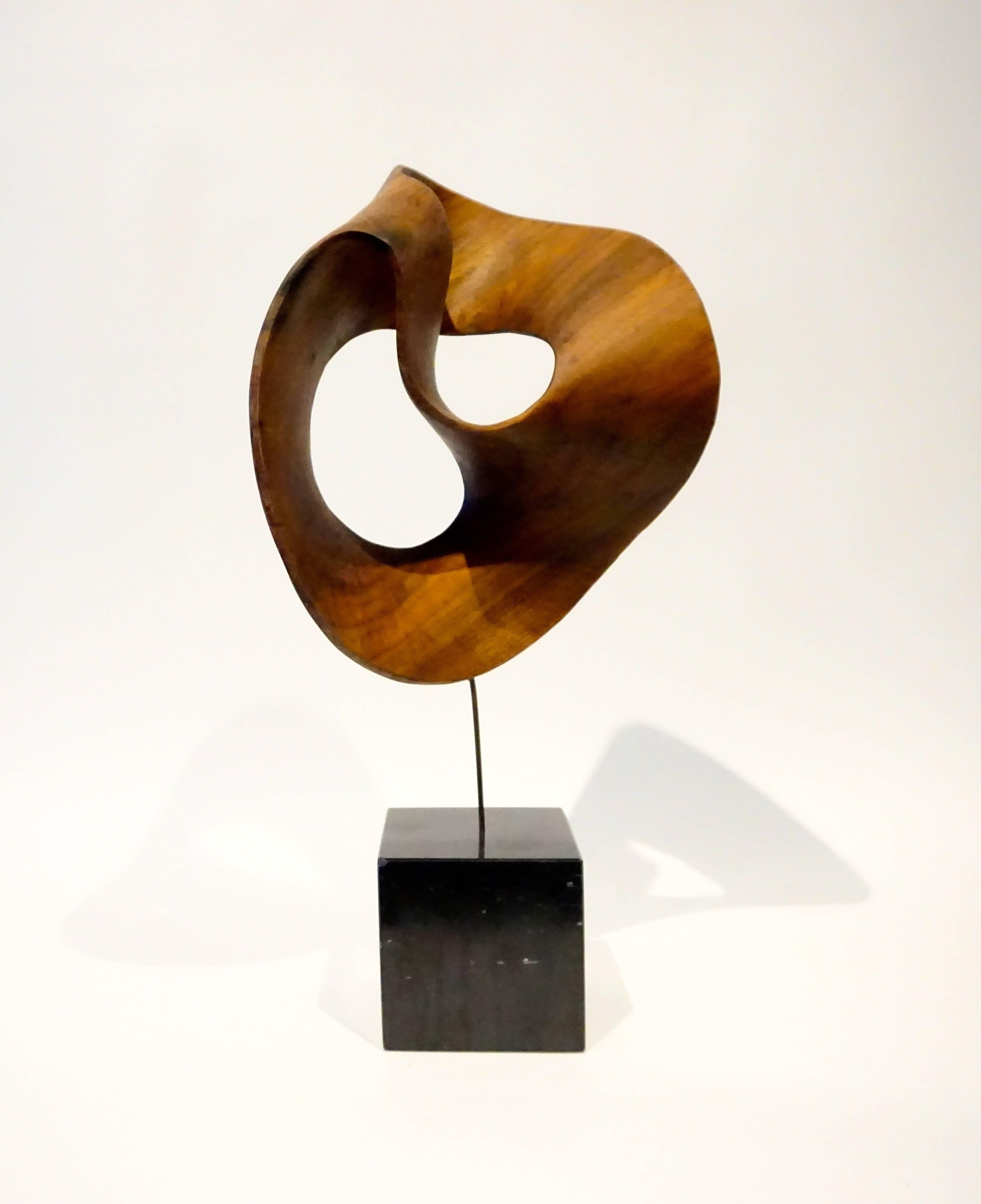 A carved wooden swirl sculpture by American artist Thomas E. Woodward (1932 - 2011) from the 1990s. Woodward was a Yale graduate and an architect by training, who in the 1990's began to sculpt using a variety of materials including marble, bronze
