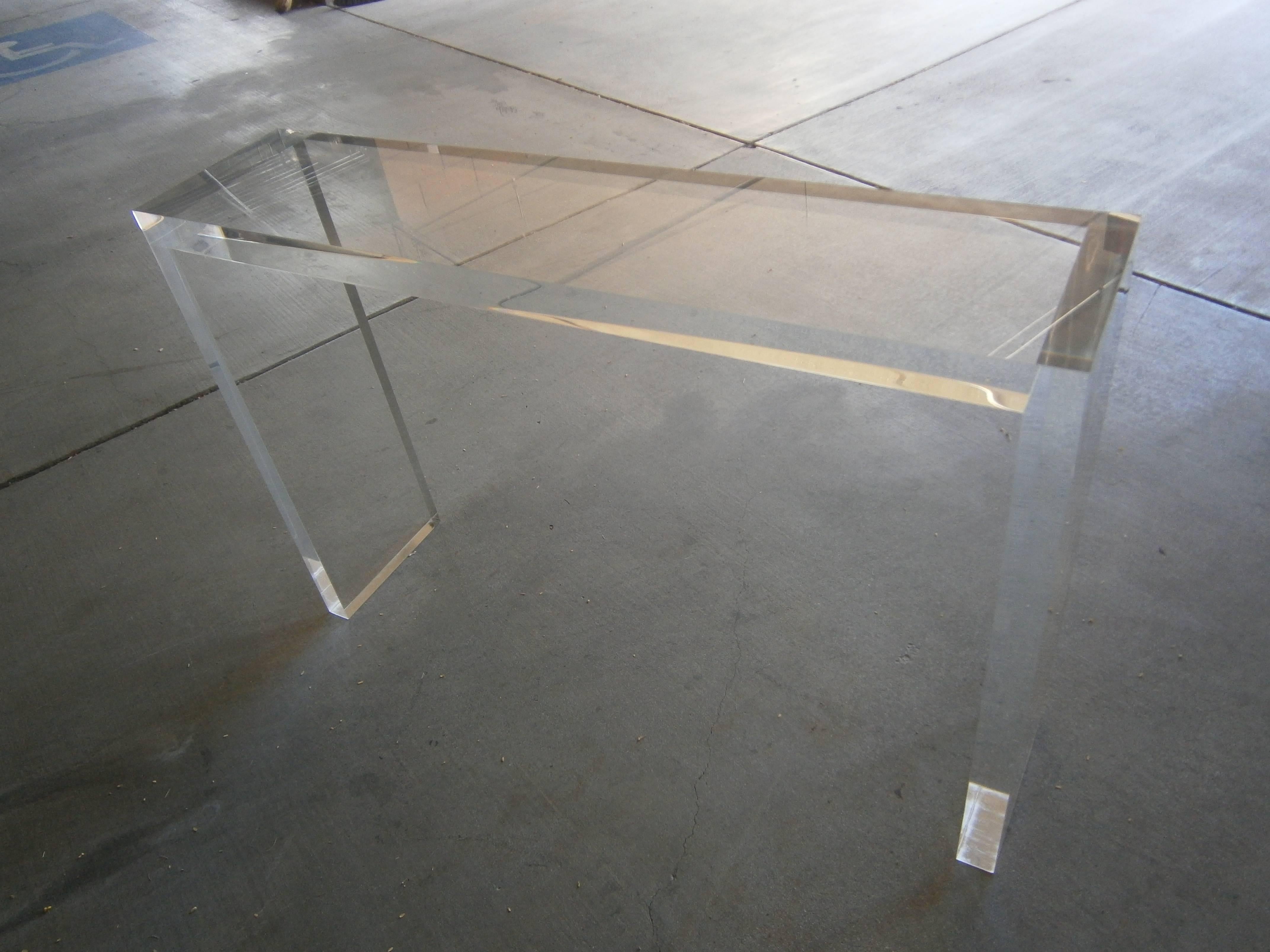 A sleek and shallow depth Minimalist console table manufactured by Carmichael Furniture. The table is made from 2