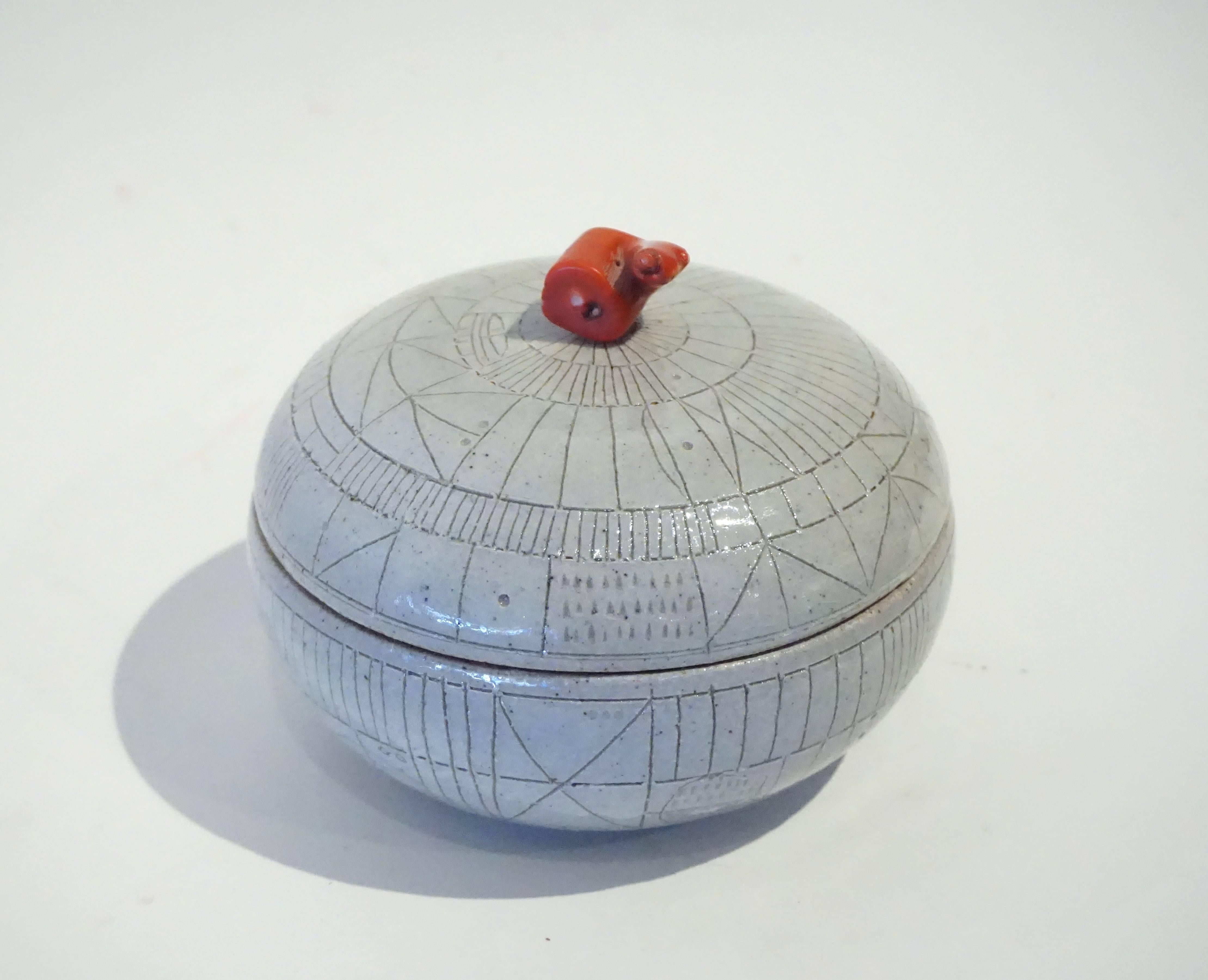A pale gray scribed lidded ceramic box with coral handle by studio potter Heather Rosenman, 2016.  HR2142