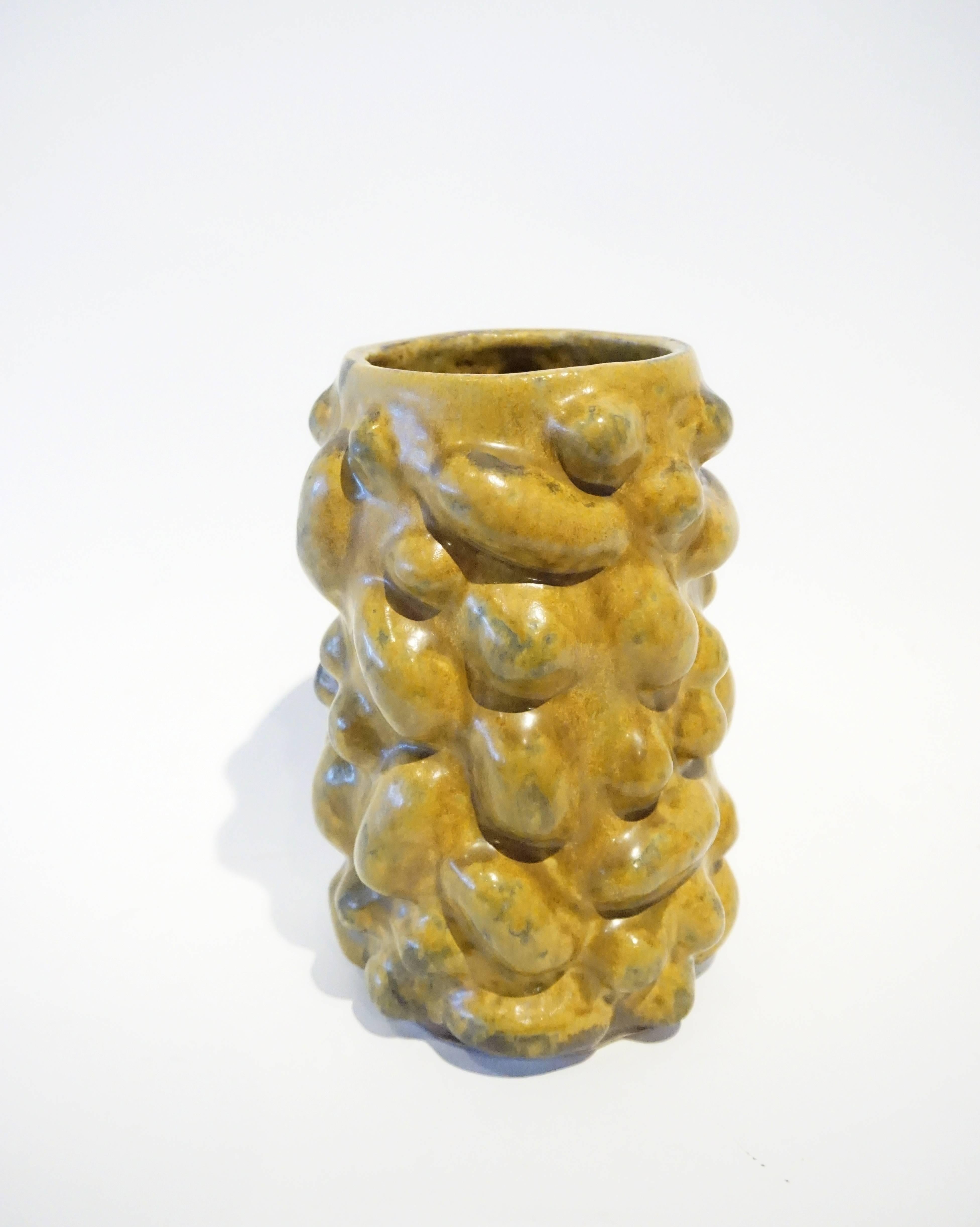 A glazed ceramic vessel by American studio potter Warner Walcott. C. 2016.  The formed stoneware vessel is finished in a semi-gloss mustard colored glaze and exhibits the influence of famed Mid-Century Danish artist, Axel Salto.