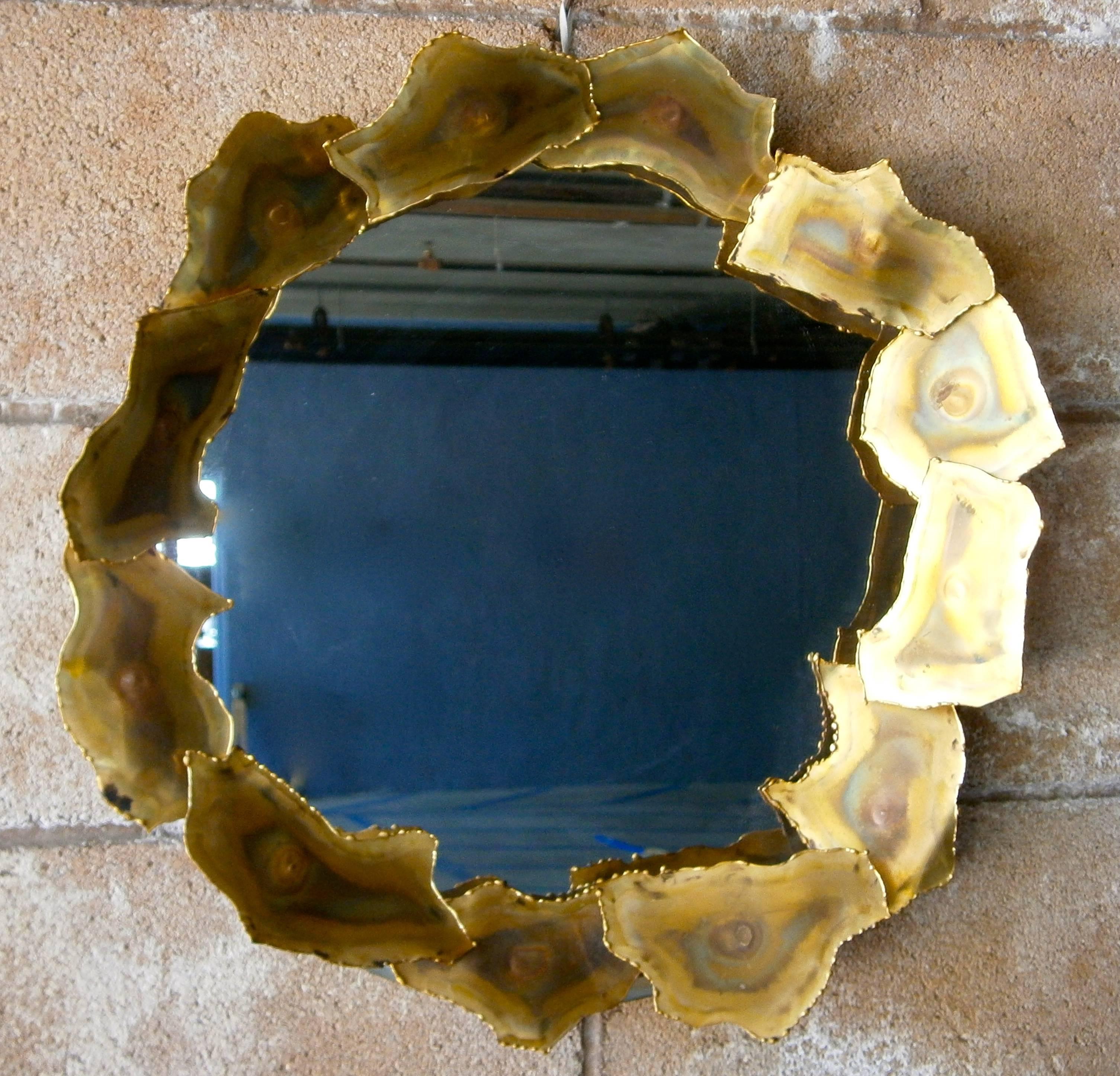 A small sculptural mirror with torch-cut brass elements made by Artisan House /  / Curtis Jere, circa 1960s.