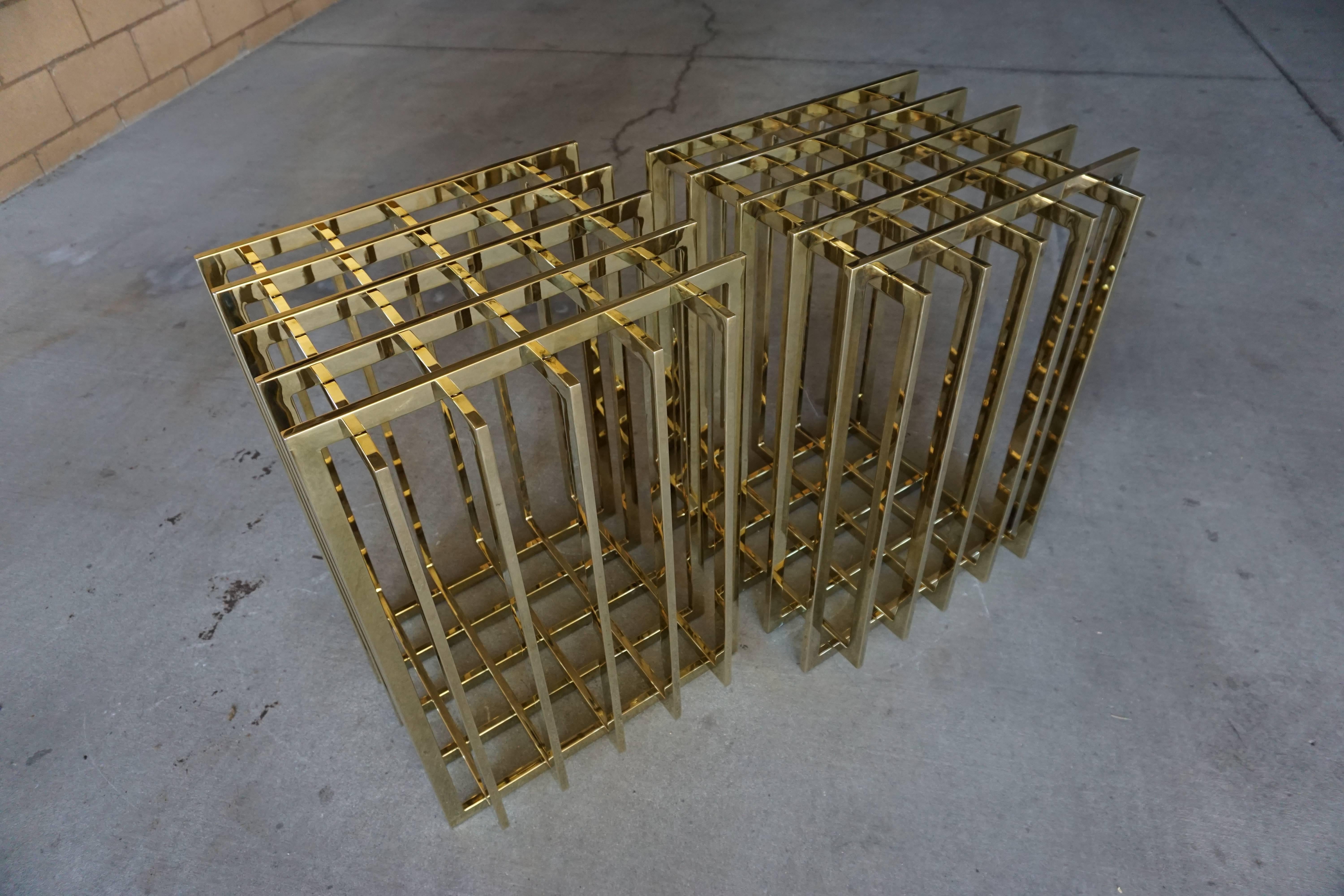 A pair of brass-plated steel dining table bases, designed in the 1970s by Pierre Cardin and possibly made by Dillingham. Each of the cage-form pieces is moveable and can be used in the square, gridded format or in a diamond shape. The bases are