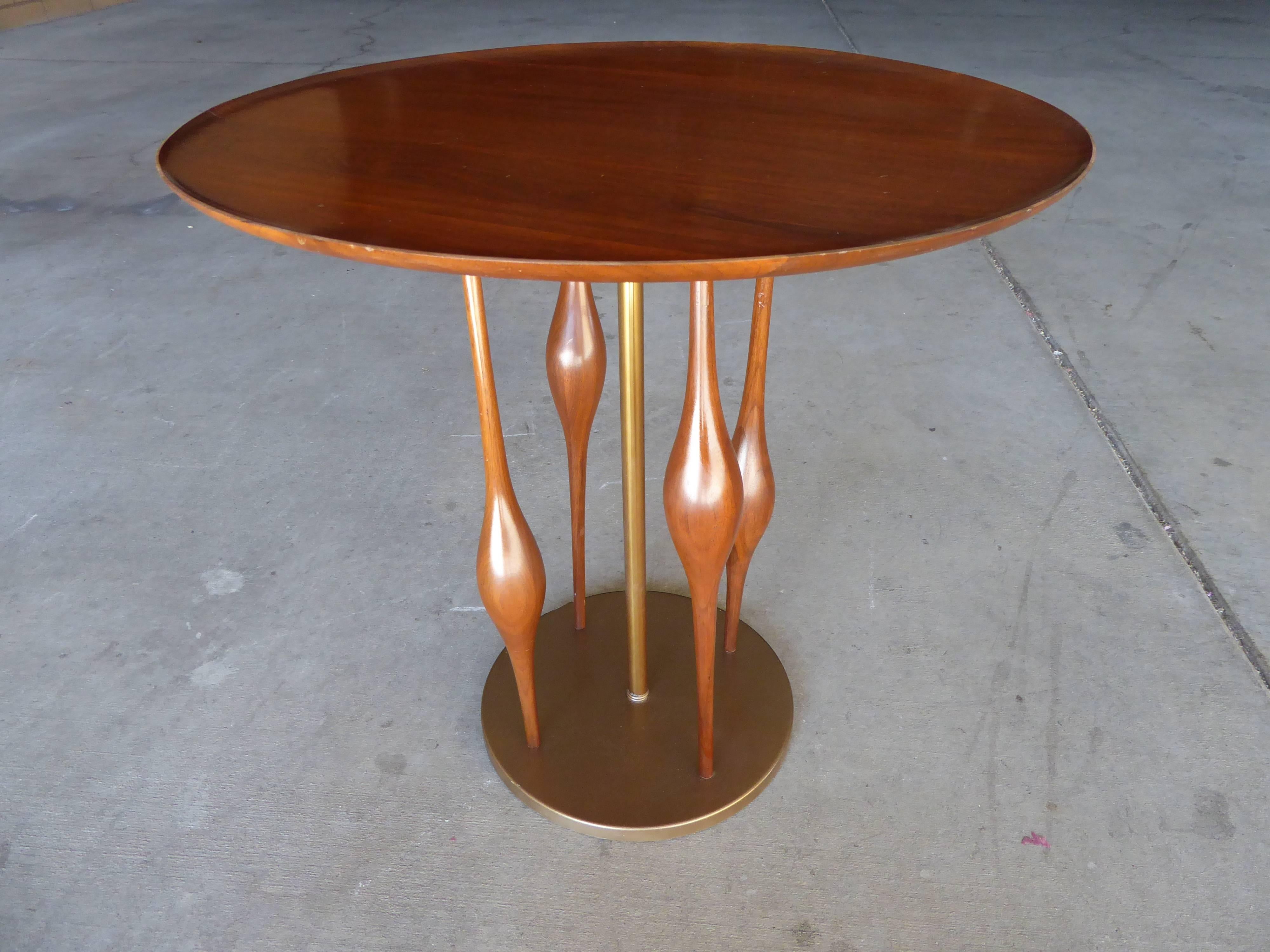 A wonderful and whimsical mahogany side table with a tray top and sculpted spindle supports with a brass center post and base. Manufactured by Mode Line with a design attributed to Adrian Pearsall.