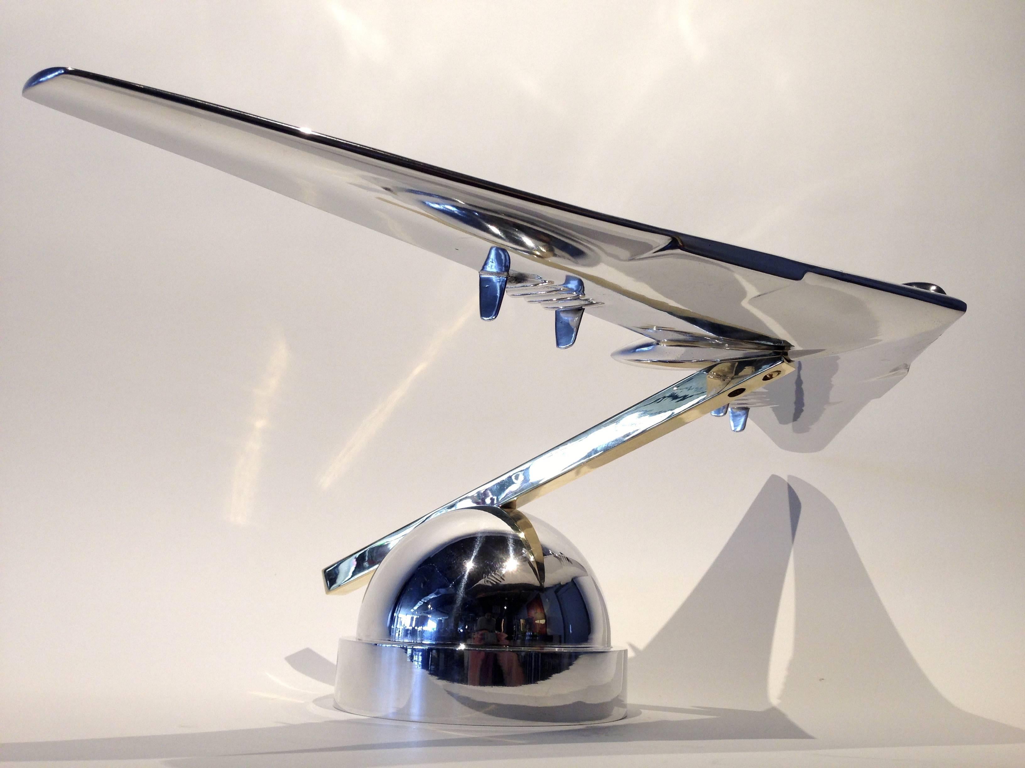 YB-49 Flying Wing Chromed Steel and Brass Sculpture By Phil Miller C. 2015.
This amazingly accurate contemporary sculptural replica is custom built and mounted on a brass square rod and a beautiful matching hemispherical base.
This Flying Wing is