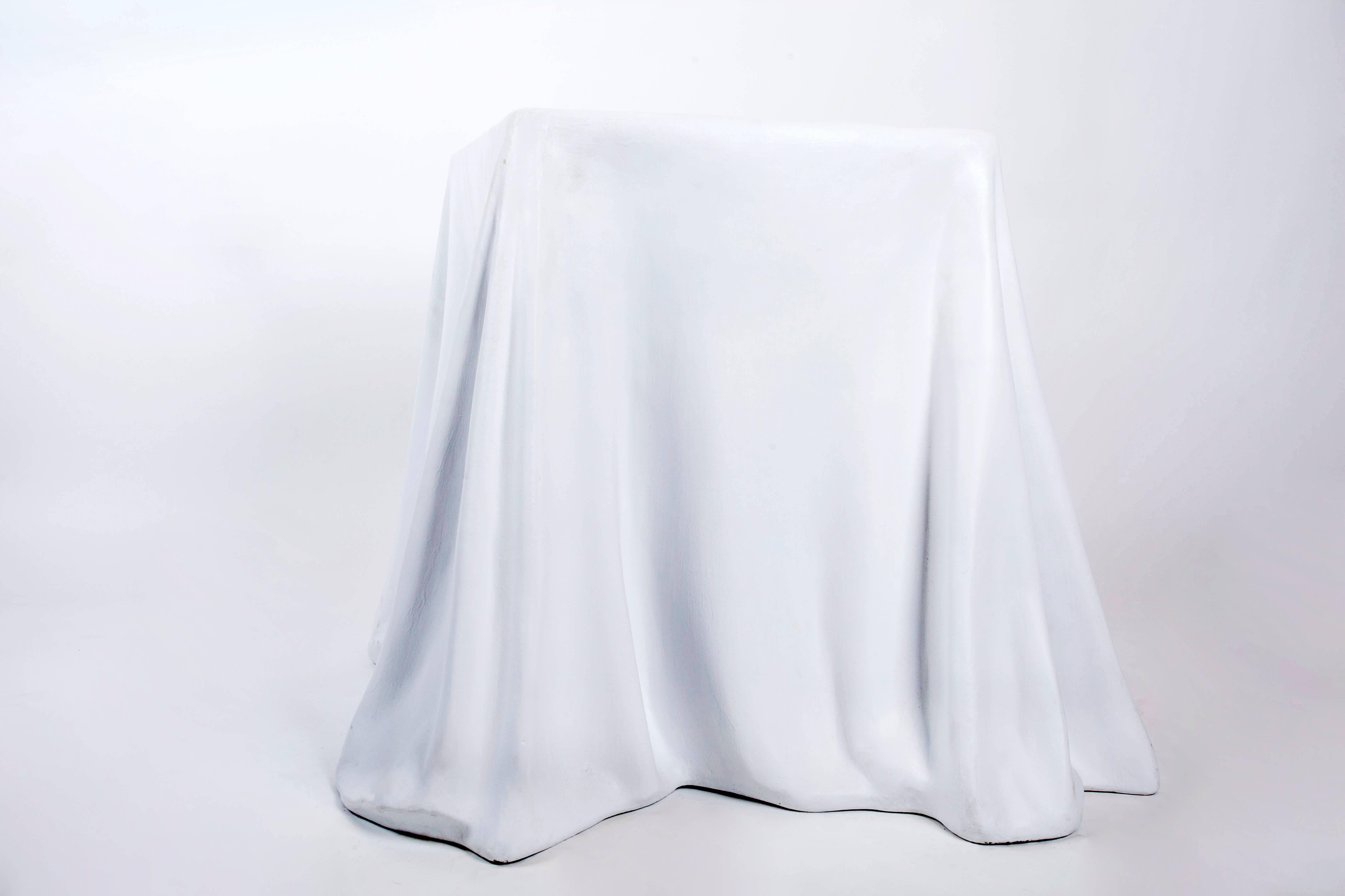 A realistically modeled draped plaster side table from the 1980s, designed in the manner of the Tovaglia table by Alberto Bazzani for Stendig. The moulded plaster has been fortified with fiberglass for durability and has been newly painted white.