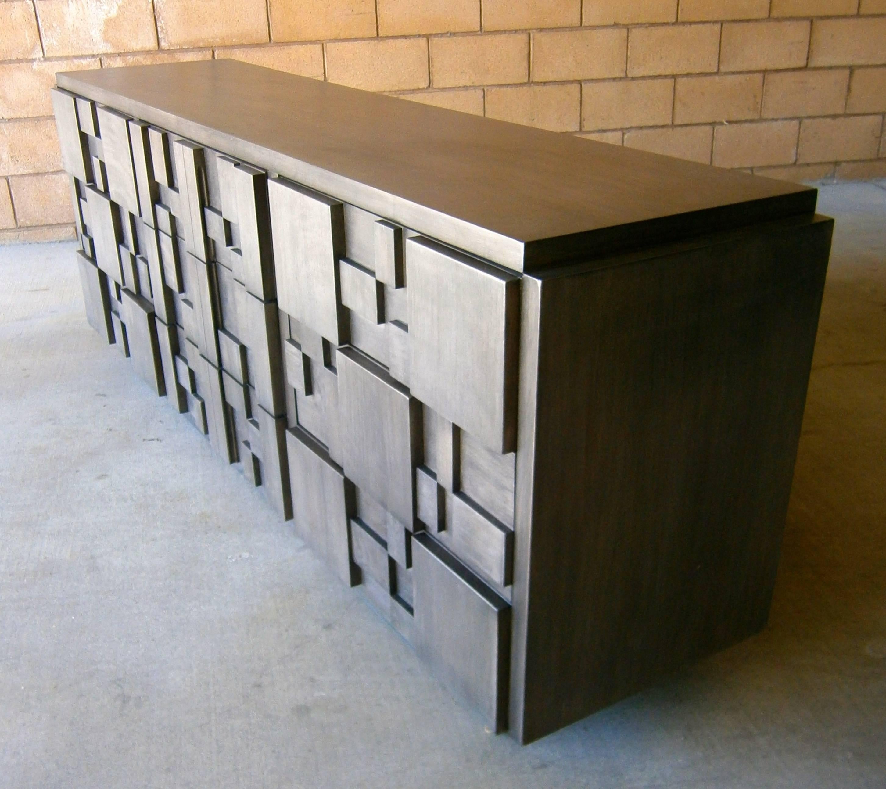 A nine-drawer cubist inspired mahogany chest manufactured by Lane Furniture in the 1970s. The chest has been newly restored with a gray-stained finish which allows the grain of the wood to show through.