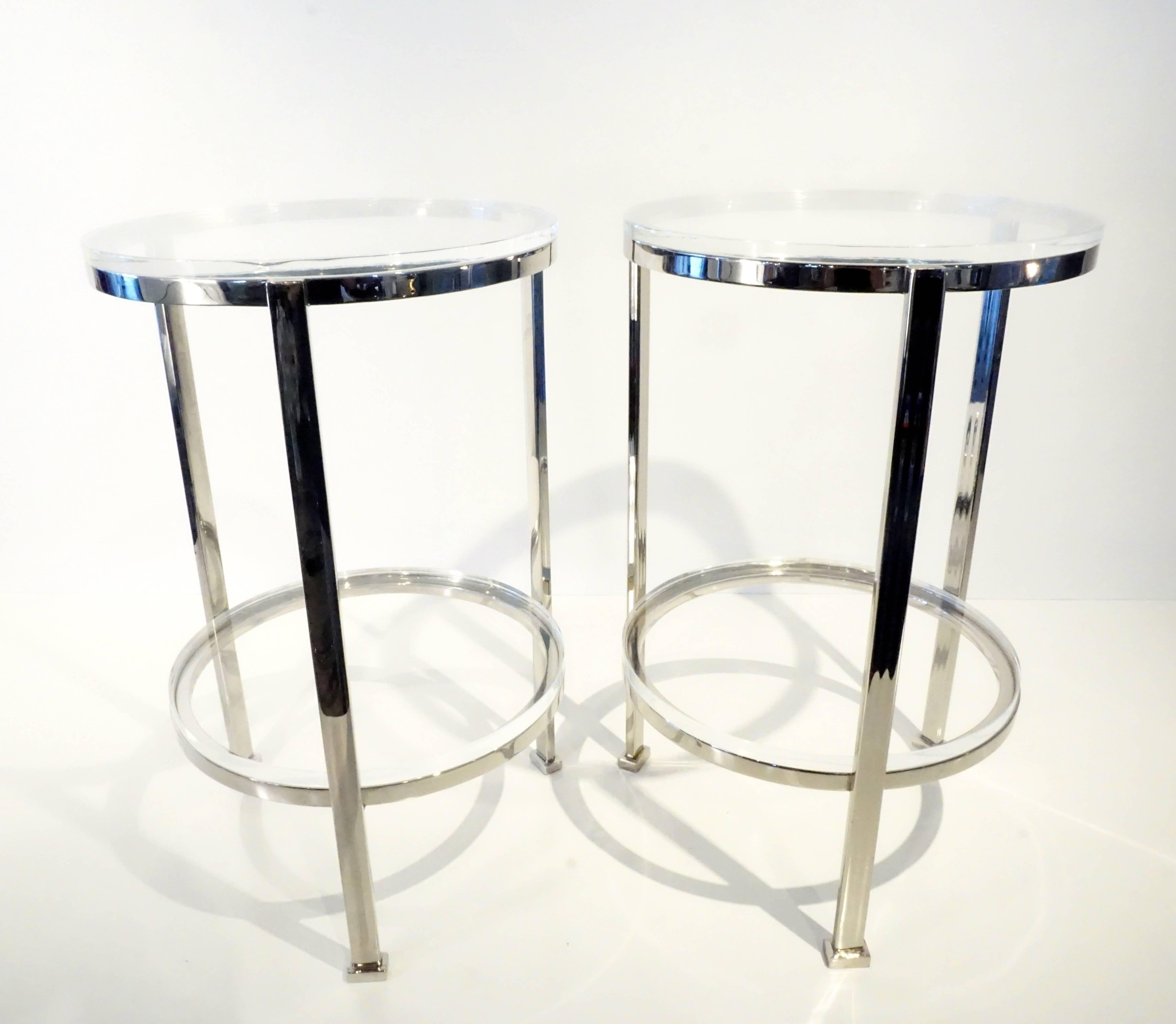 A pair of custom-made two-tier circular side tables made by Charles Hollis Jones C. 1990. The frames are fabricated from solid nickel-plated steel and the shelves are Lucite, with the top shelf having a rabbeted edge. The tables were acquired from