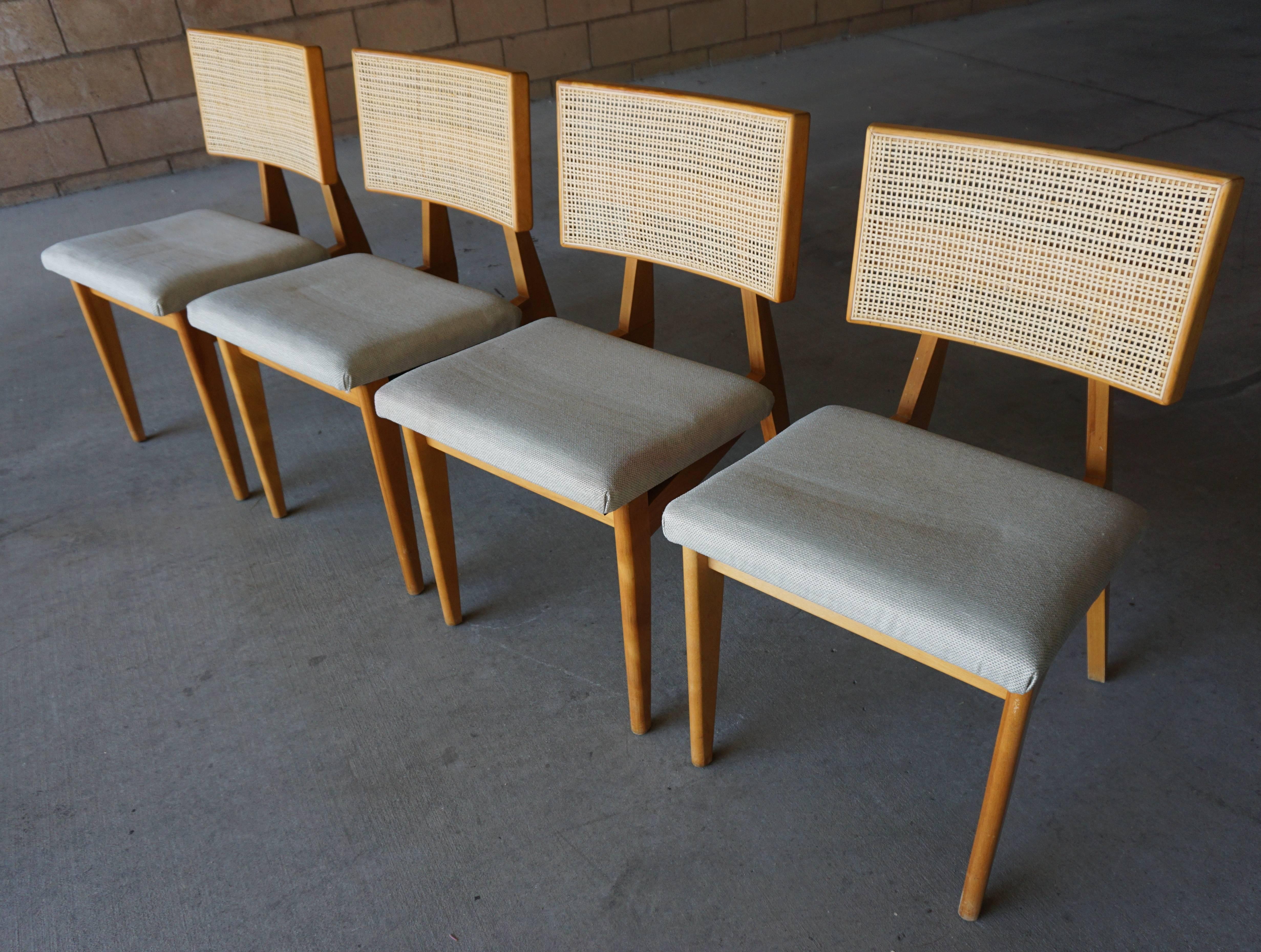 A rare set of 4 American beechwood side chairs with woven cane back rests, designed by George Nelson for Herman Miller in the 1940's. The finish on the wooden sections of the chairs is original and the caning also appears to be the original. The