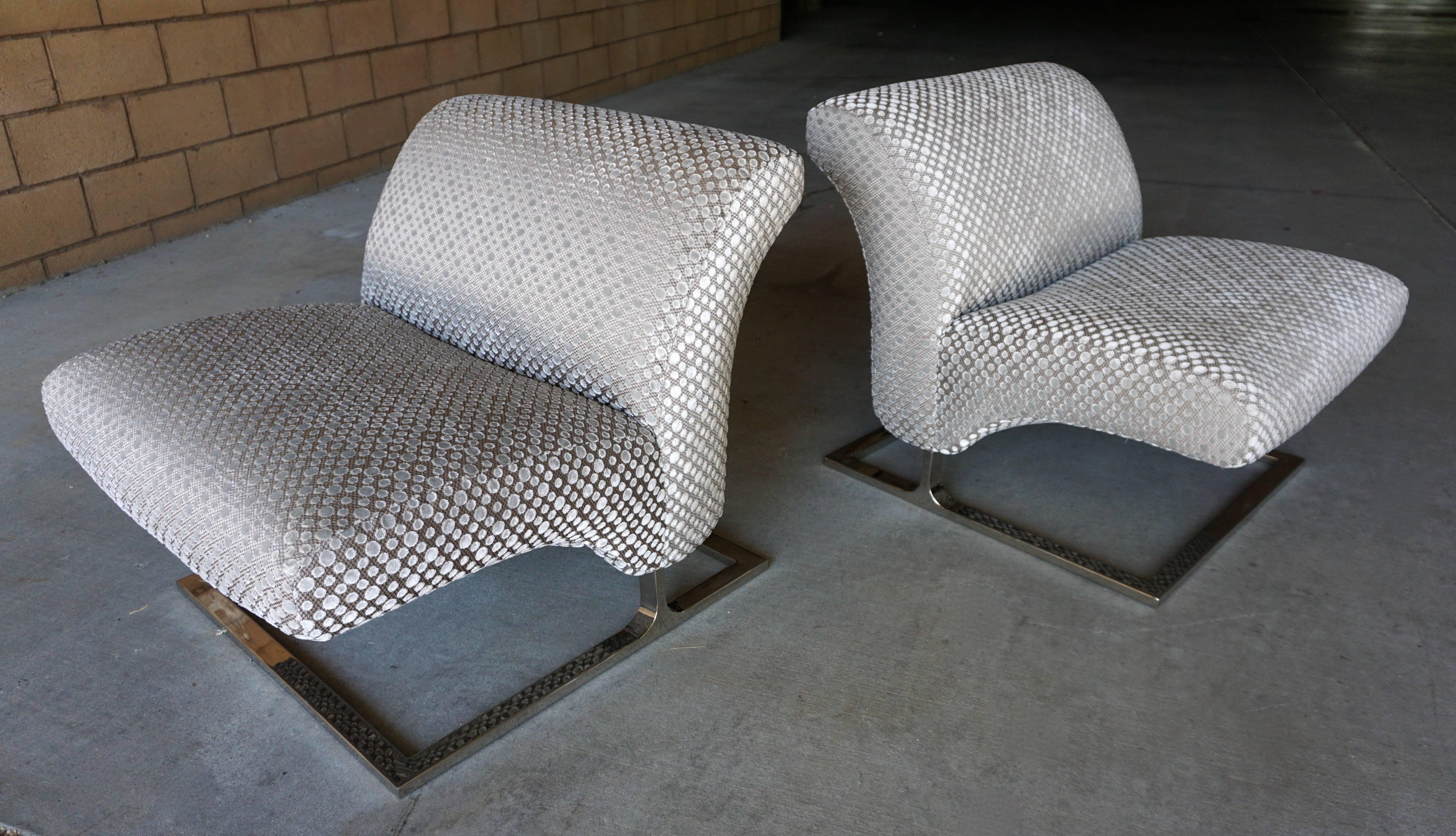 Strikingly handsome pair of cantilevered lounge chairs with nickel plated bases, circa 1970's.  Newly reupholstered.