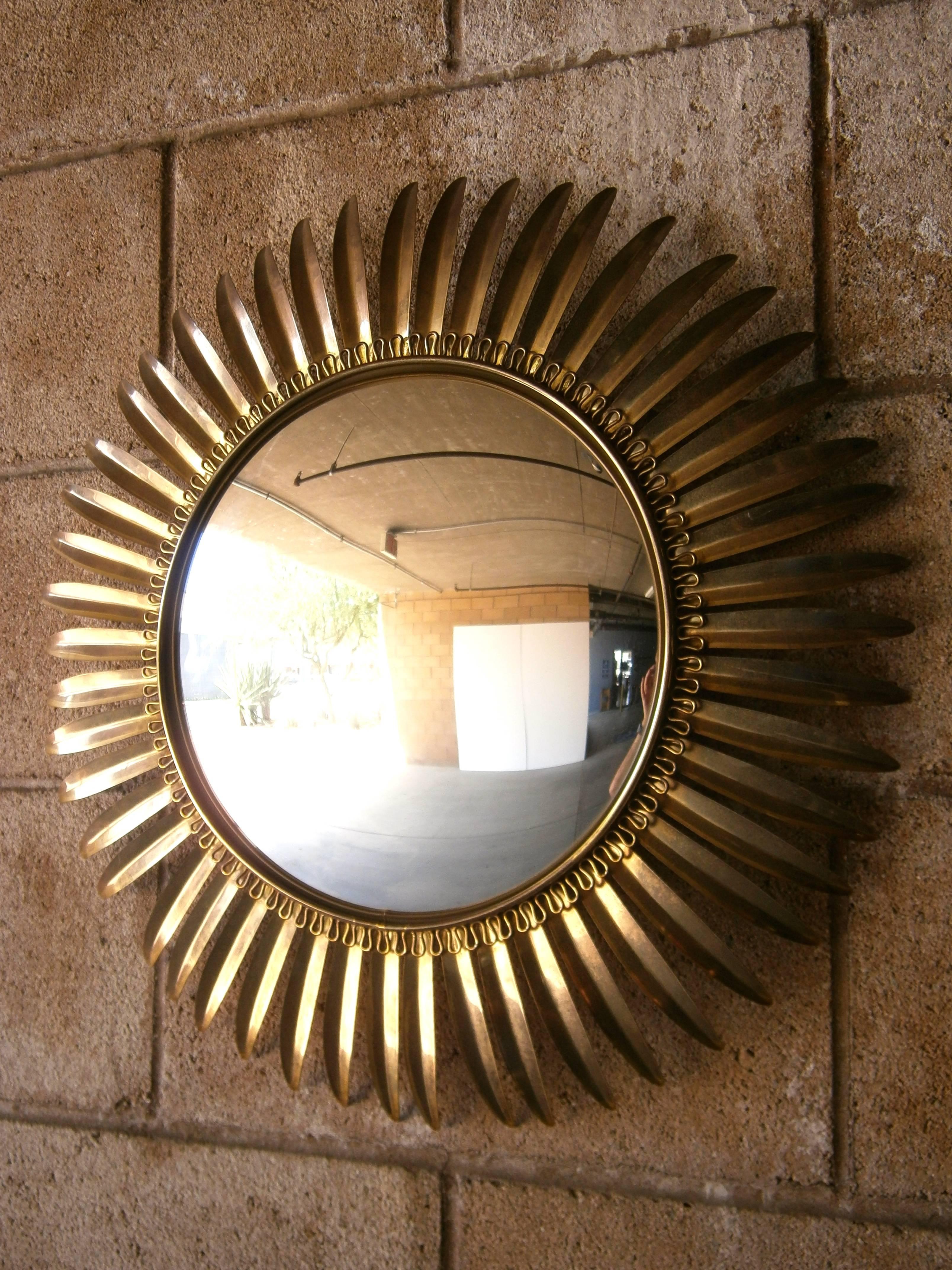 A beautiful and sophisticated Italian mid-century convex Sunflower mirror in brass c. 1960's.