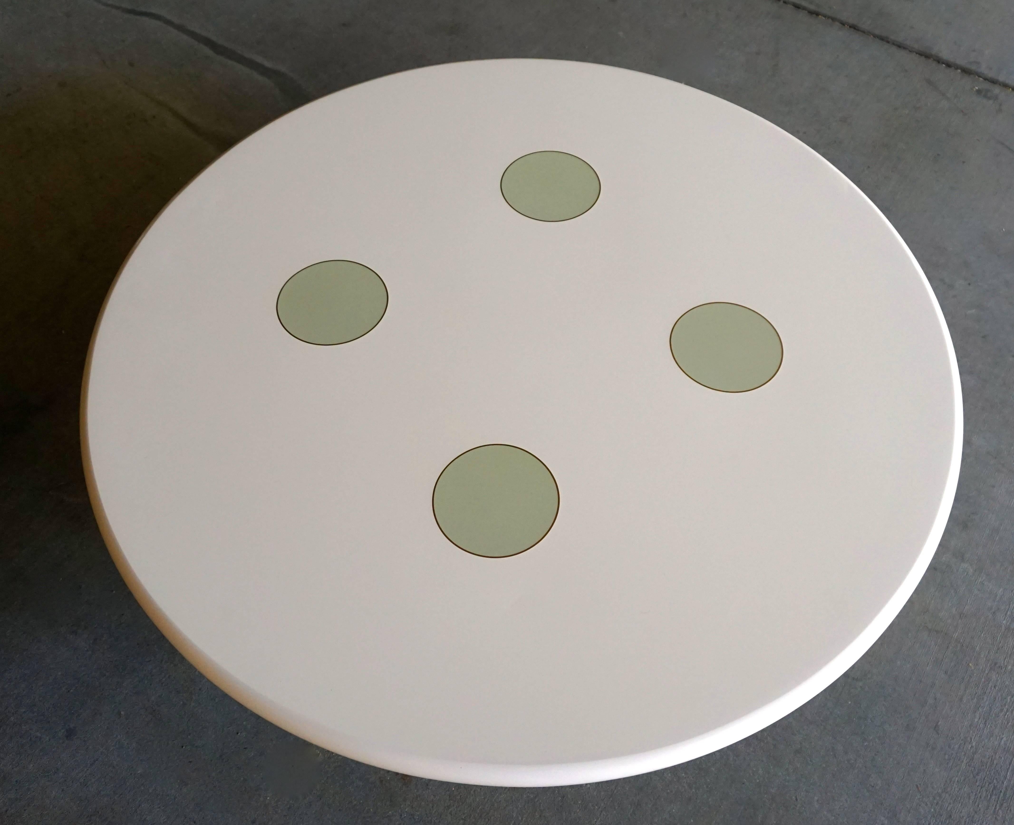 A dynamic and whimsical custom made lacquered wood coffee / dining table with brass Inlay, circa 1980's.This table looks like a giant button, giving it a slightly surreal emphasis.  Shown as coffee table, also comes with separate dining height legs