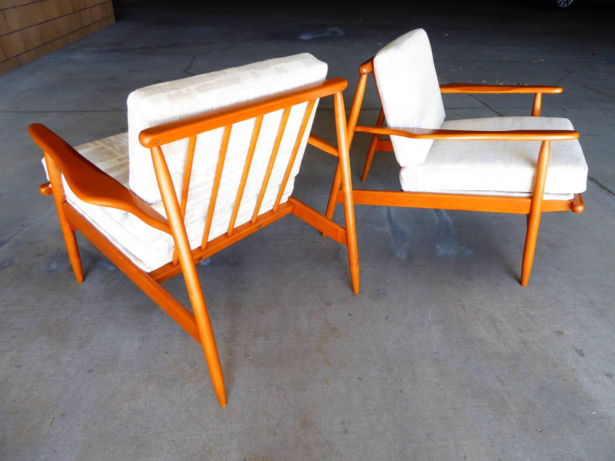 A beautiful pair of mid 20th century maple "slat back" lounge chairs. 
these chairs have really interesting lines with a deep set back on the legs and a reverse angle on the slat supports. The chairs are extremely comfortable.
these are