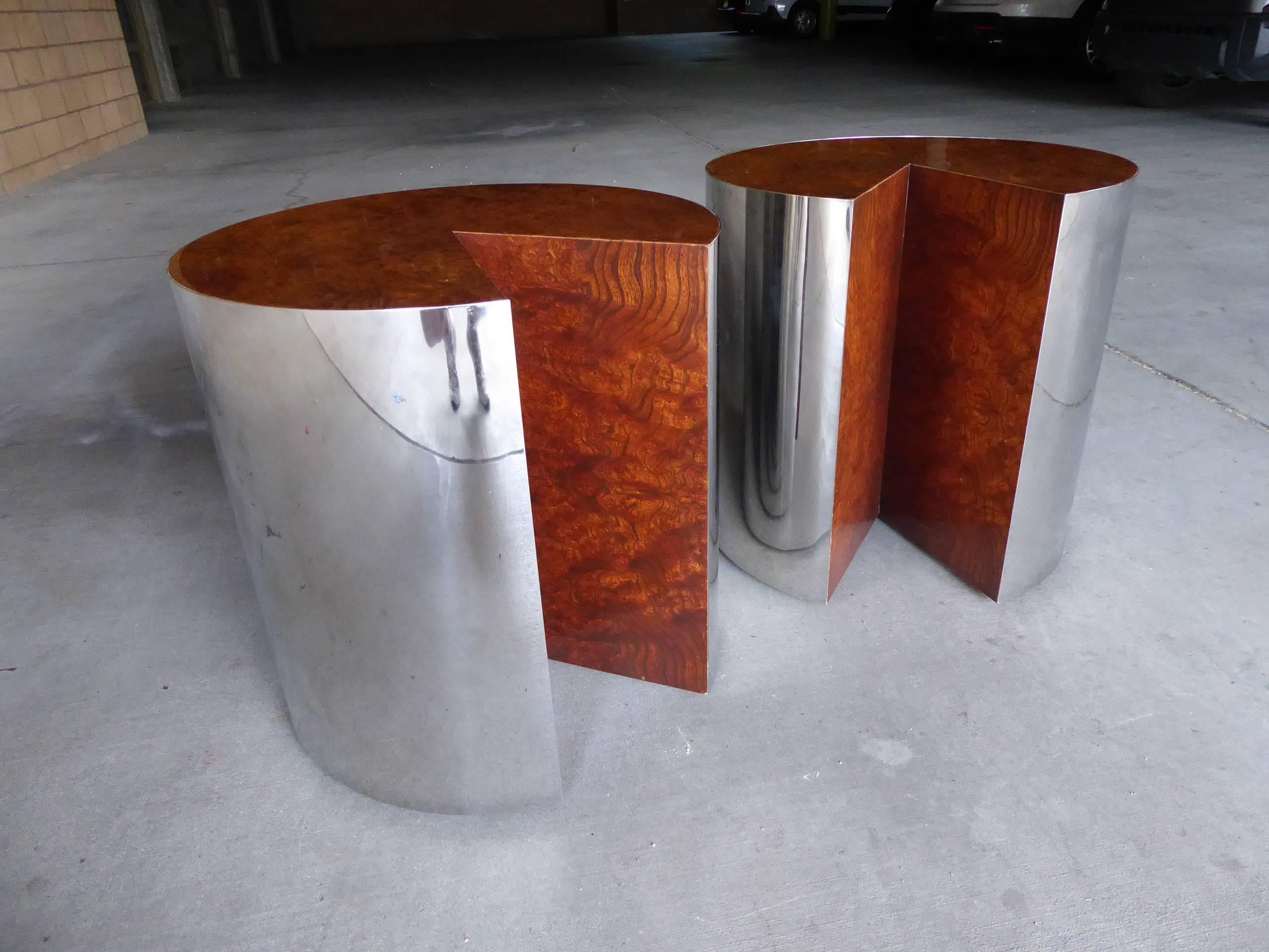 A pair of burled wood circular side tables, wrapped with a polished steel exterior by Pace Collection, circa 1970s. Each of the tables has a wedge shaped cut-out which adds a playful twist to the design (you might even remember that in the old