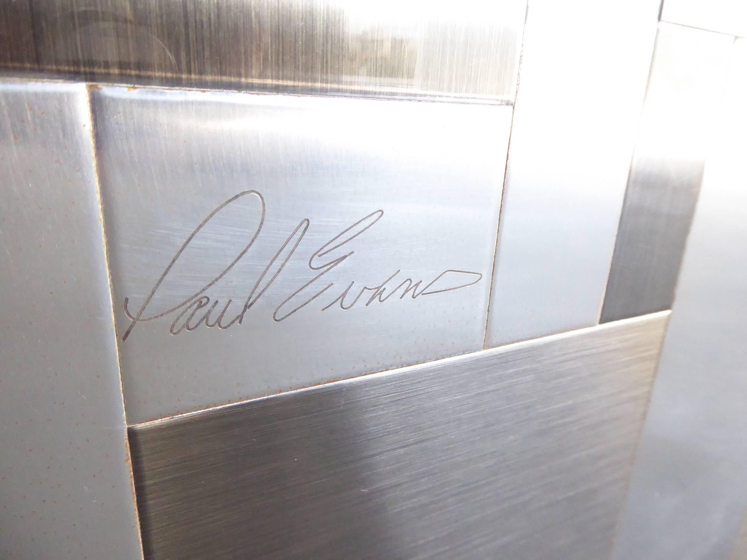 A rare and extraordinary gun metal, polished chrome and brushed chrome octagonal dining table base made by Paul Evans for his Cityscape collection, circa 1970s. Signed with a plaque bearing the cursive signature.
The Cityscape collection was