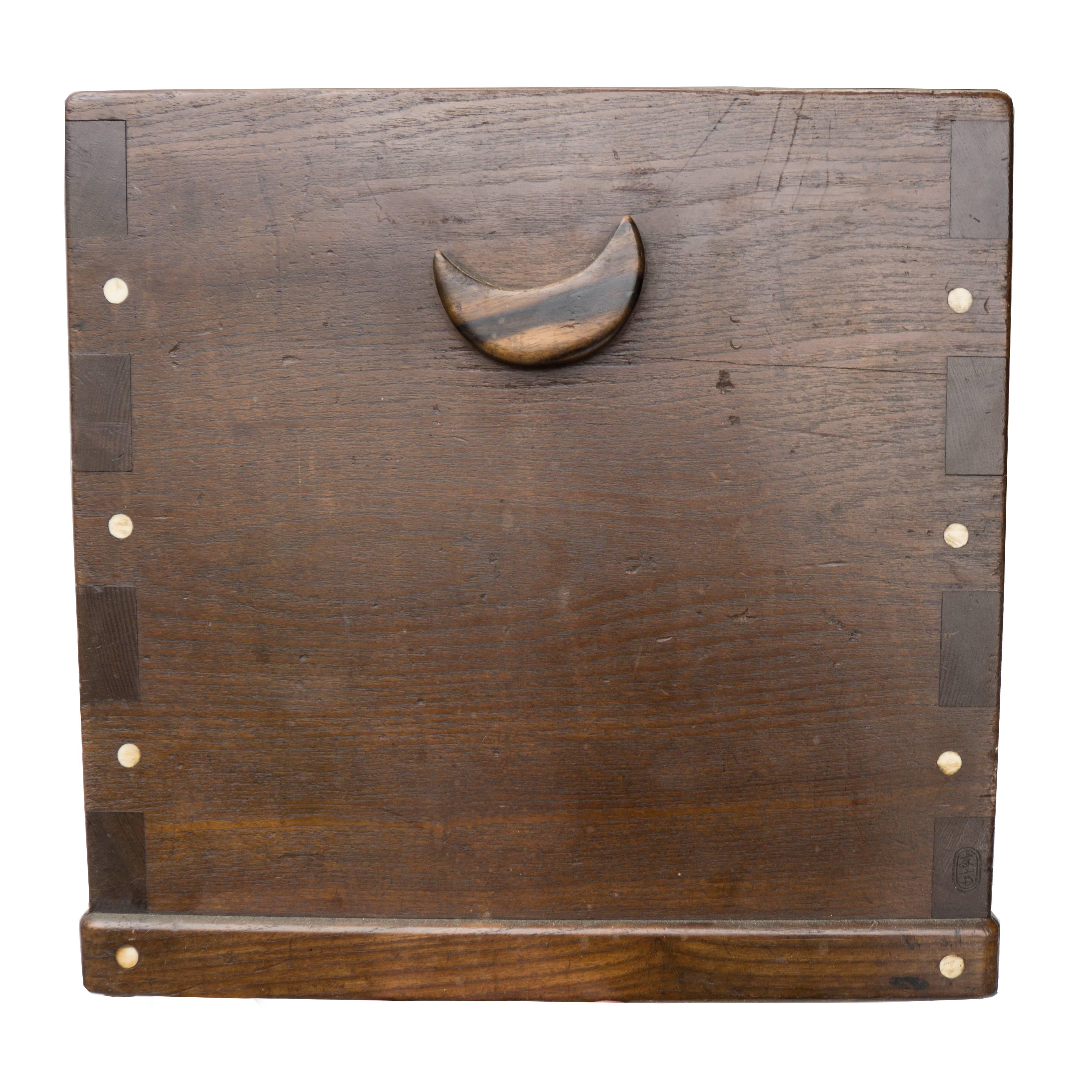 Lovely wood and copper cube with open top and crescent moon side handles, circa 1920; this Japanese box adds a warm presence to any room.

 
