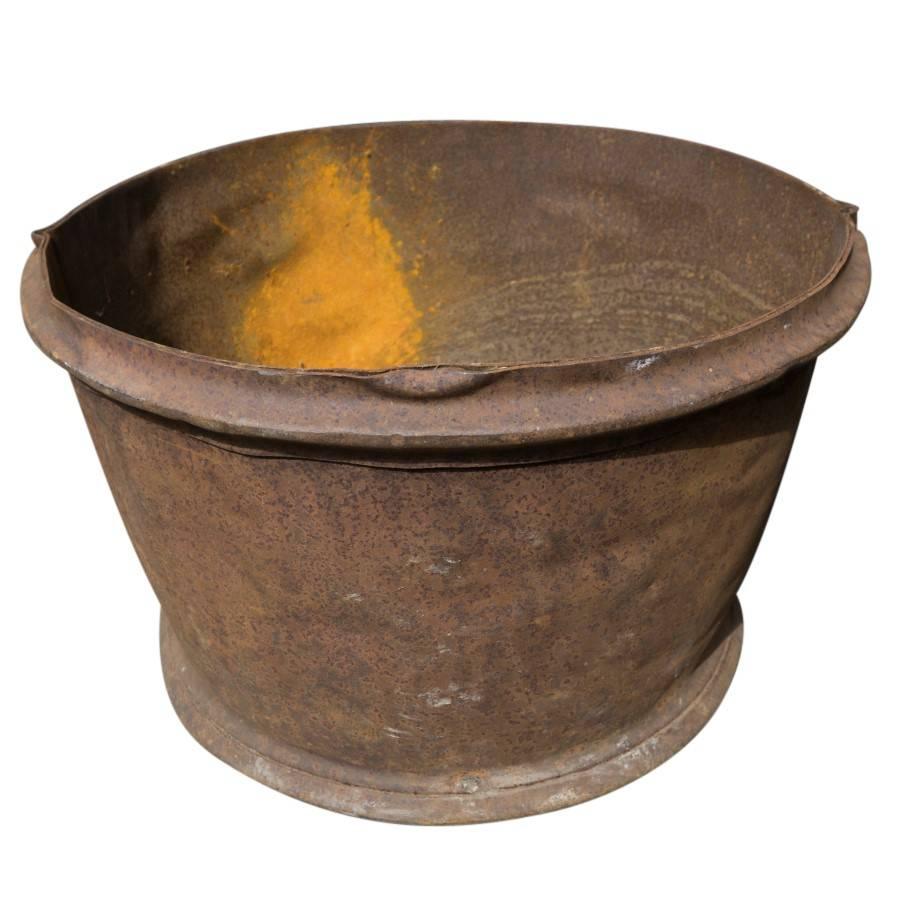 This handmade French iron container is over two feet in diameter and stands 16 inches tall. Unique in design and far from modern shapes of mass produced planters, the container has a warm character provided by the earthy brown rust and