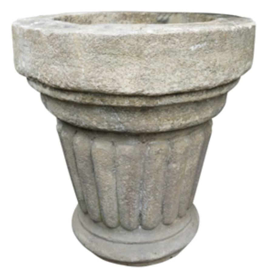 Antique French reconstituted stone planters for indoor or outdoor gardens, circa 1910, these planters are hand crafted with a style and knowledge of centuries old stone mason tradition. With a 28 inch wide top, tapered down to a fluted stone