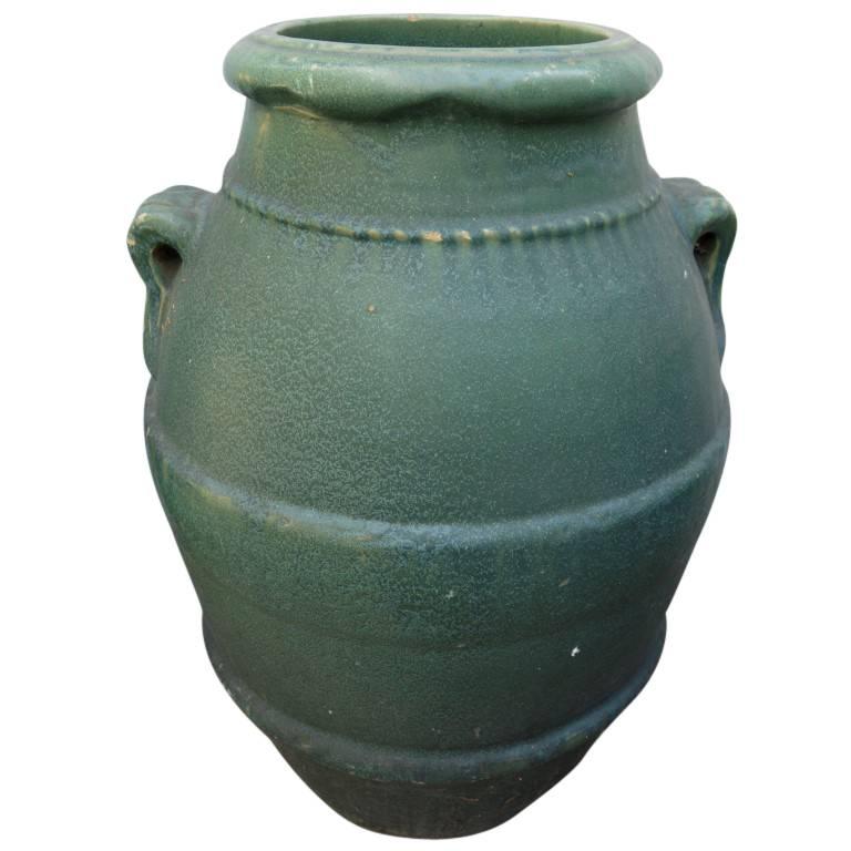 Each inscribed with GMB 50 these authentic Gladding McBean oil jars are made of terracotta and covered in a thick turquoise glaze. Standing 28 inches tall and with a diameter of 20 inches in the wide center the jars feature smooth curved loop