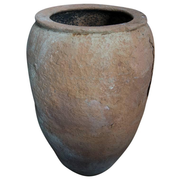 A wonderful red hue of terracotta, textured body tapering down to a narrow footing yet handcrafted perfectly to stand alone in balance. A lovely addition to your home or garden, with areas of smooth and coarse texture as well some cracks and chips,