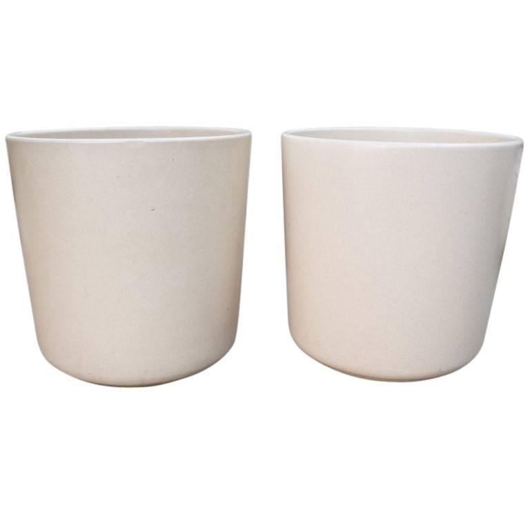 Bisque style Malcom Leland planters in vintage condition similar to the artists item LT-15 made by Architectural Pottery. These tow charming cylinders with curved bases are just over 14 inches in diameter and height. Designed for Architectural