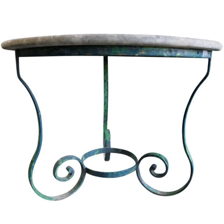 An antique table fitting for garden side or patio. At over 100 years old there is simply nothing modern that can offer the range of beauty found in this French garden table crafted, circa 1890. The smooth stone tabletop has a wonderful marbling of