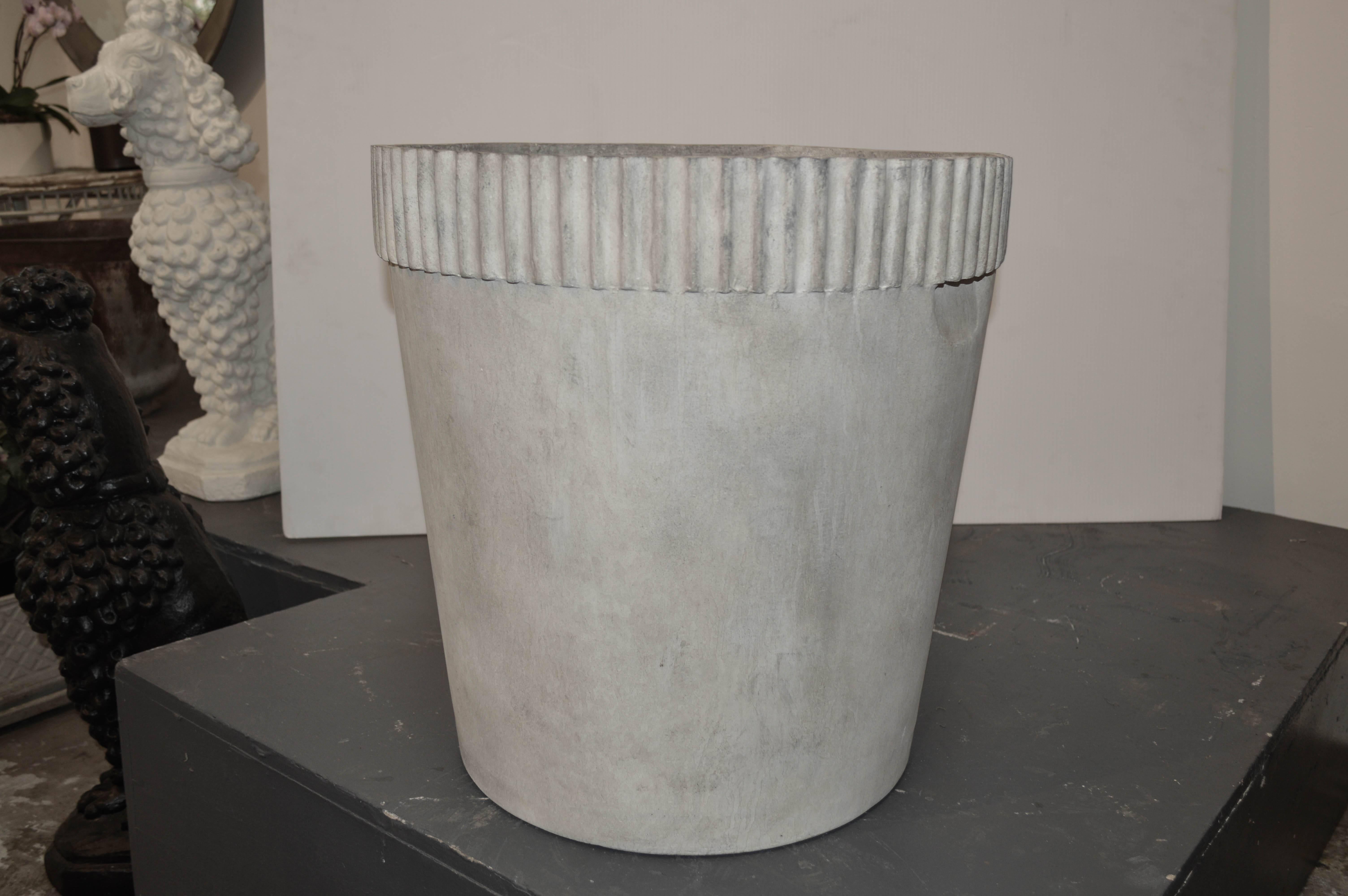 Cast fiber cement planter with ridges.
