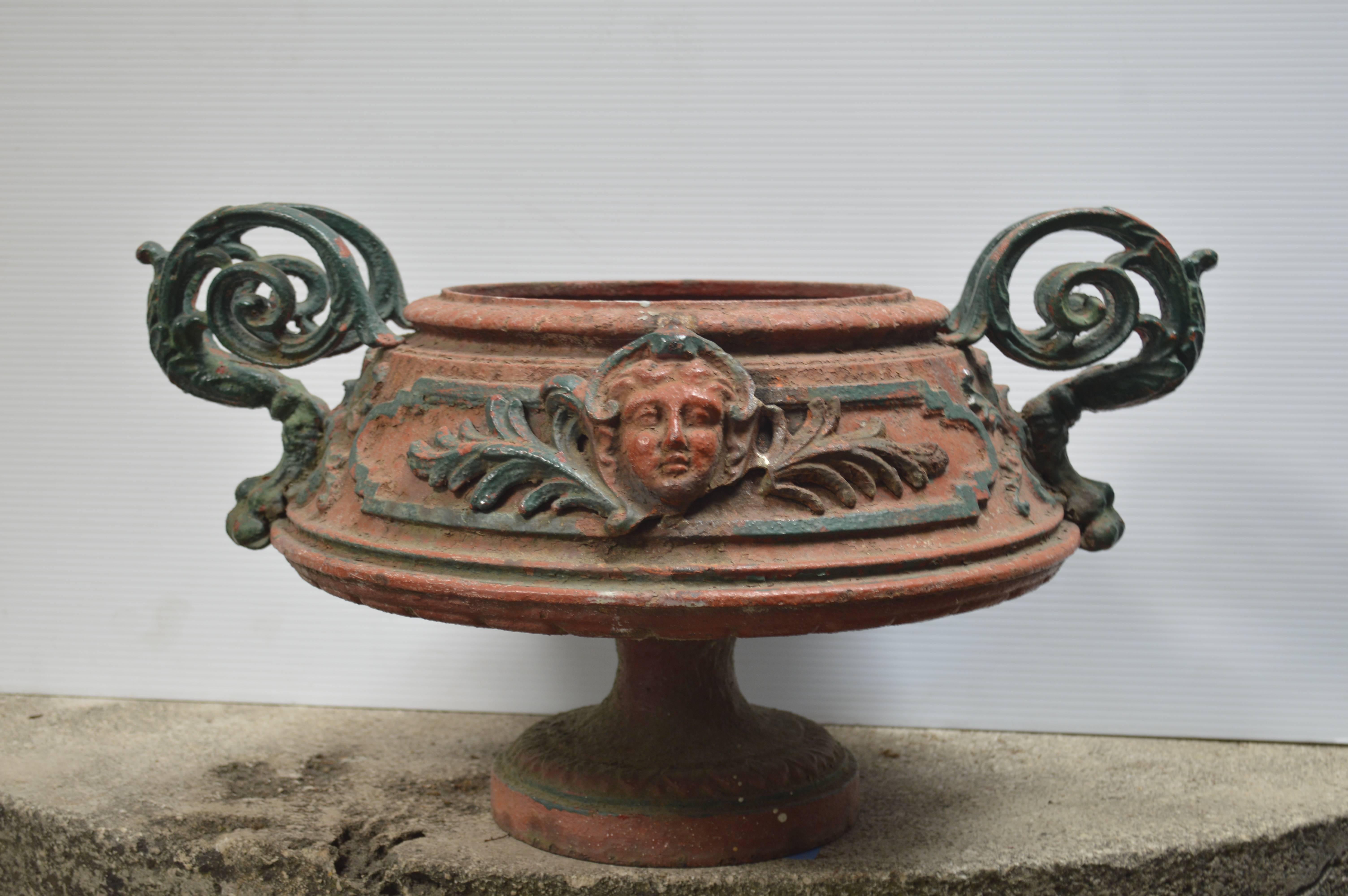 Antique 19th century cast iron Italian urn with fancy handles.