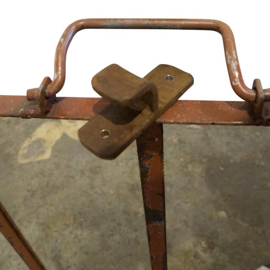 Vintage French Industrial style, square iron mirrors with top handle and wall brace. At approximately 32 inches tall and wide, these rustic iron farm mirrors are rare and charming. Inside the square frame the mirrors are split into four rectangular