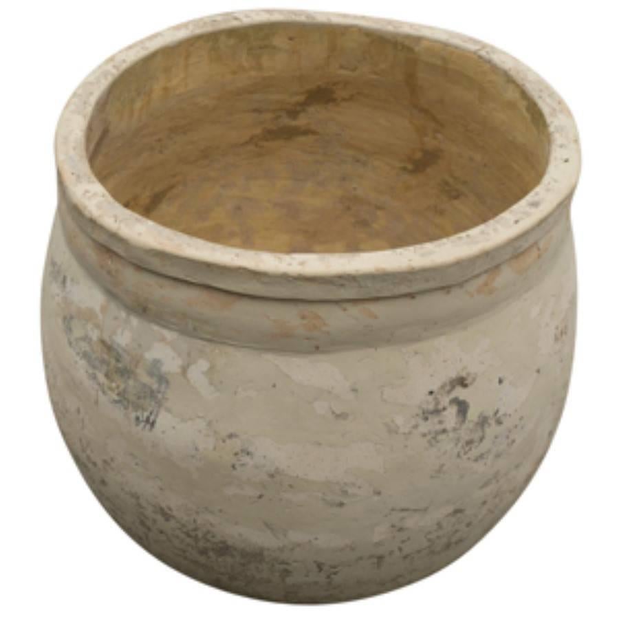 Covered in a lovely white patina and displaying timeless character of age, this Spanish terracotta antique is bold, bright and solid. A sizable planter at 29 inches tall and 28 inches wide with a deep rounded bowl for holding plenty of soil. The